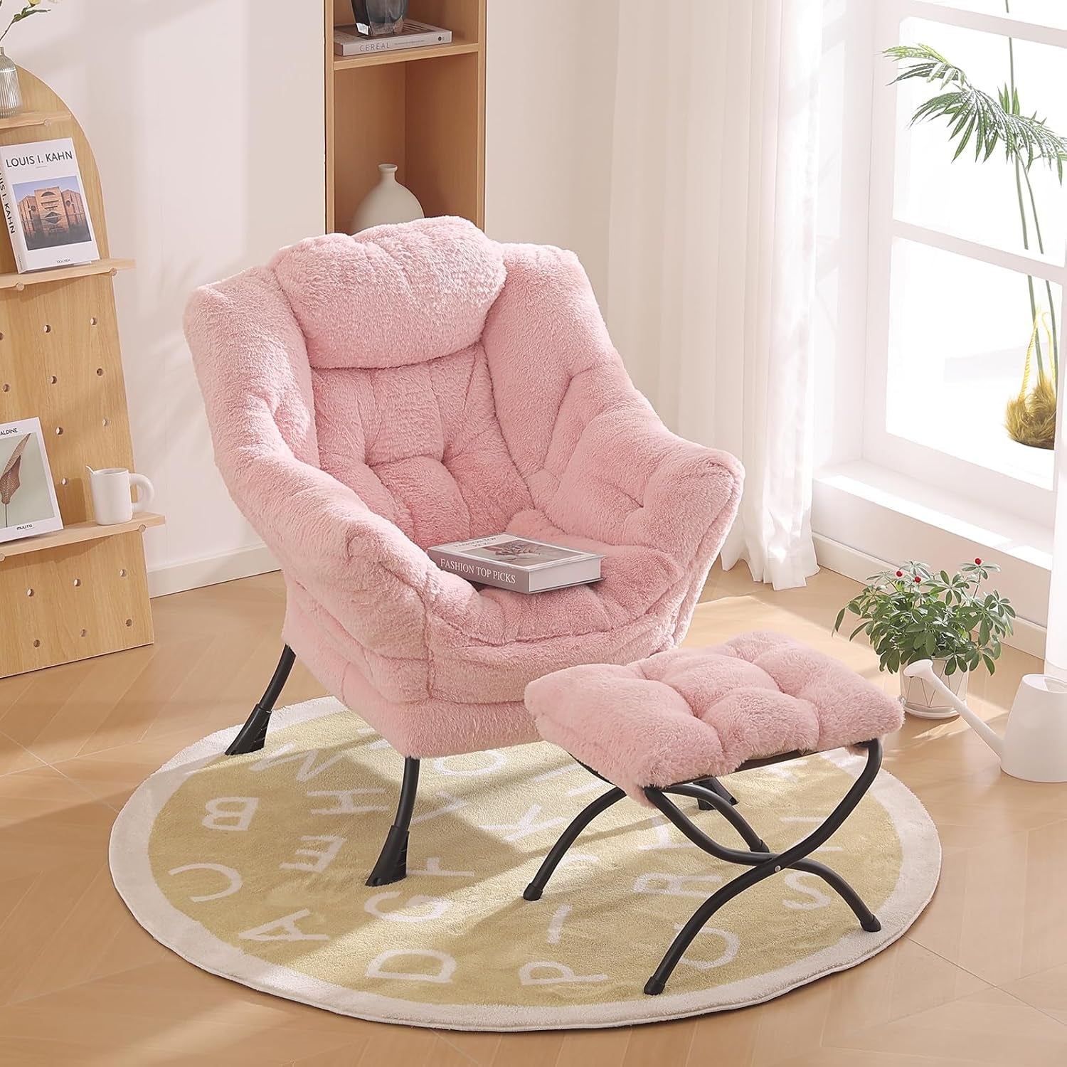 Plush pink accent chair and tufted ottoman on a round rug near a sunny window
