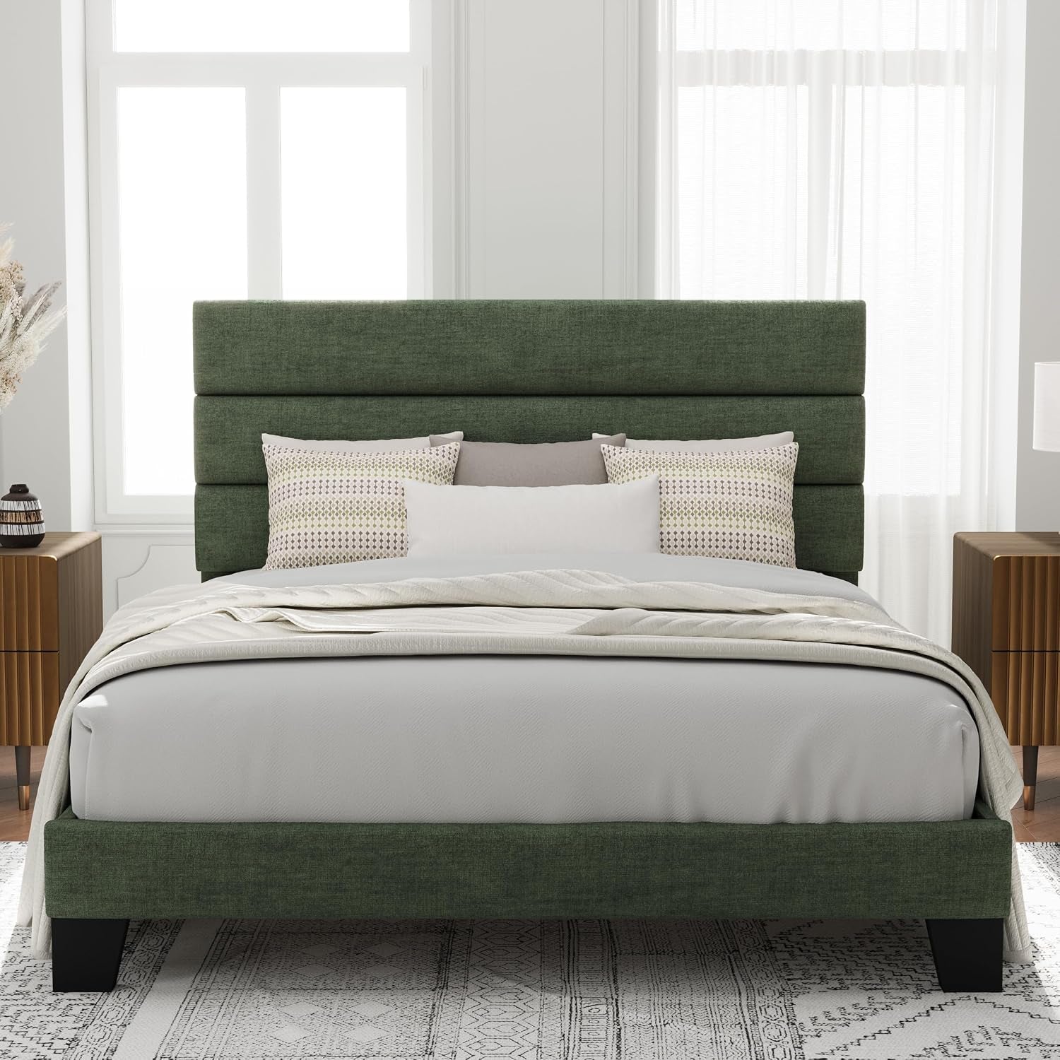 Centered room shot of a dark green upholstered bed with three headboard panels and black feet.