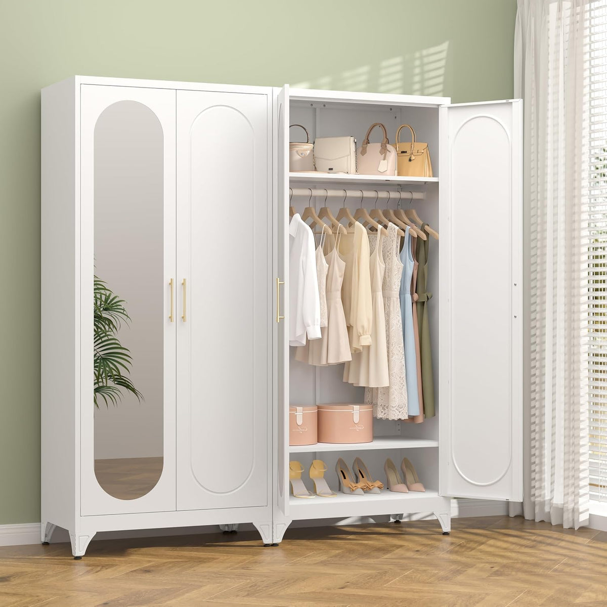 White two-door wardrobe with one door open showing hanging dresses, shelf with bags and shoes below