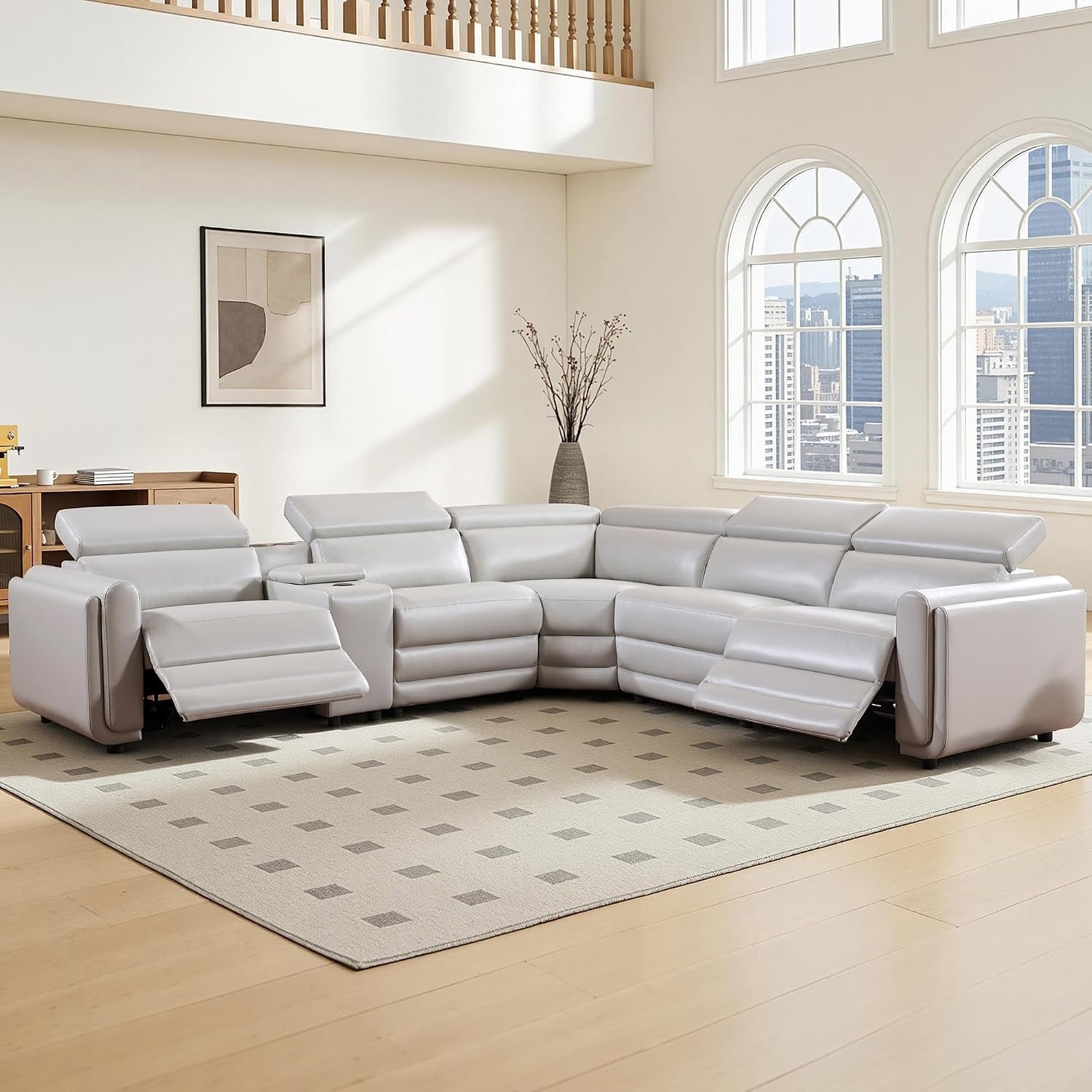 Large light beige leather power-reclining sectional with two reclined seats in bright living room