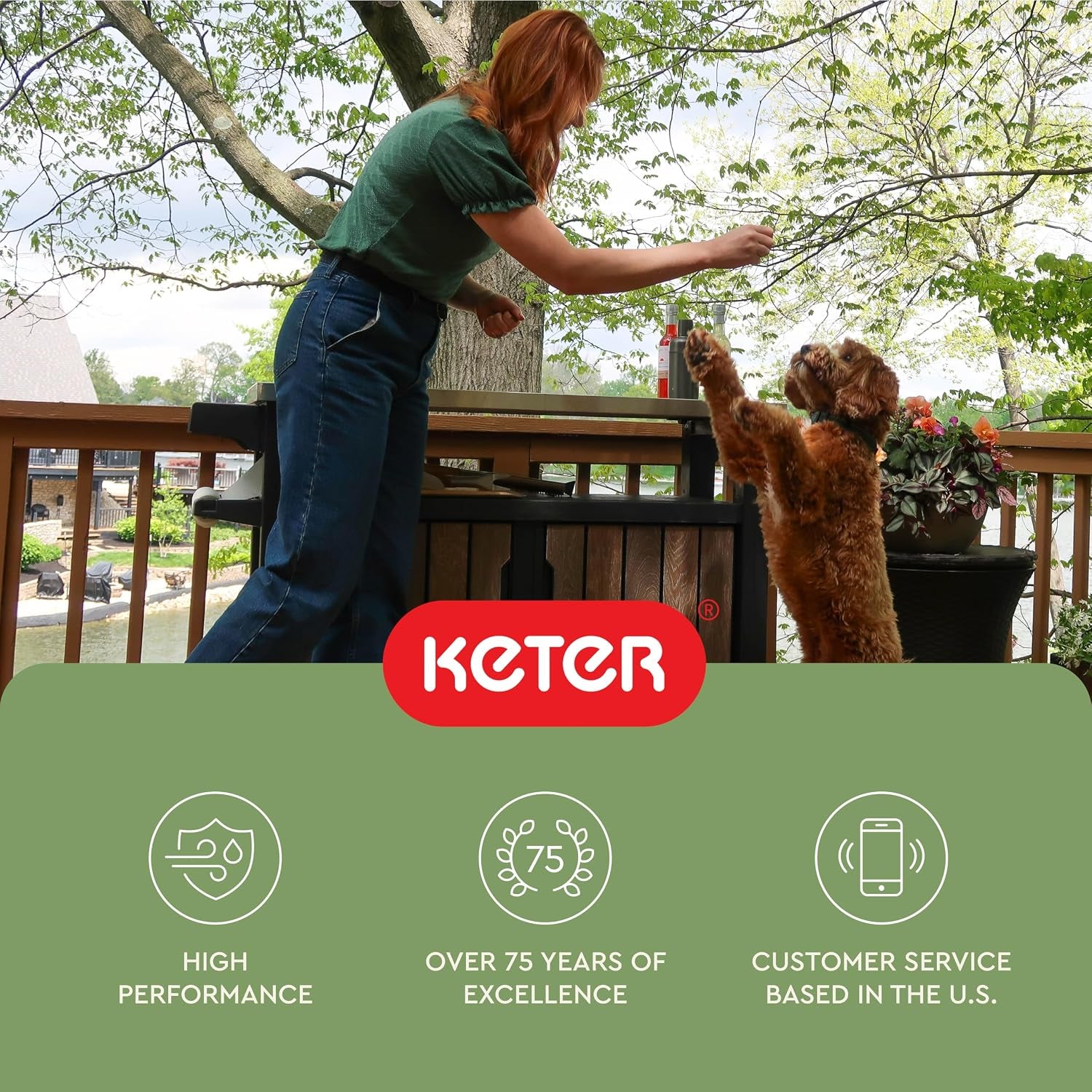 Person leaning over the cabinet on a deck feeding a small dog that is standing on its hind legs
