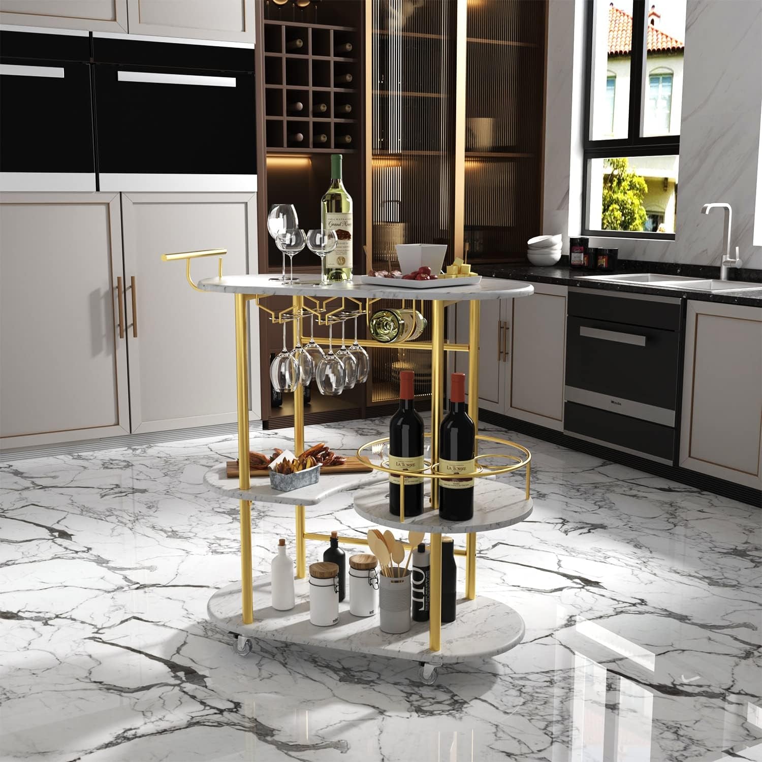 Oval four-tier bar cart with white marble shelves and gold frame in a modern kitchen