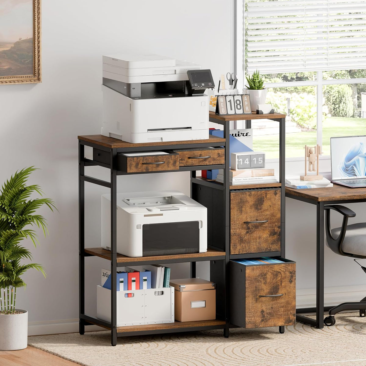 Printer stand with wood-grain shelves next to a desk in a bright home office, angled lifestyle view.