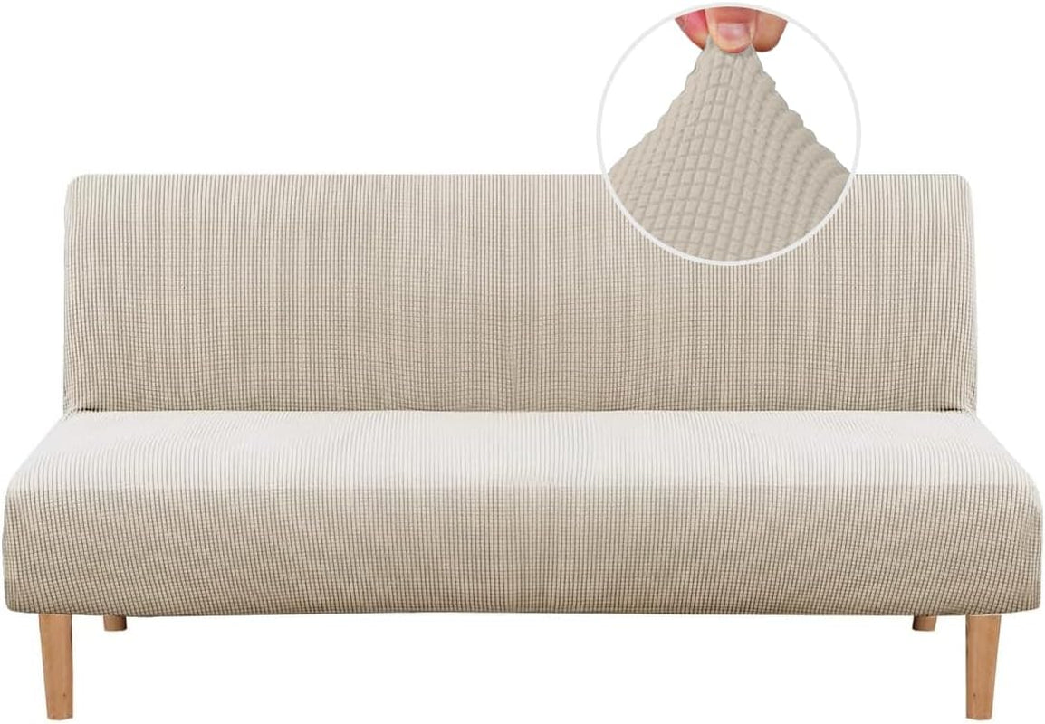 Front view of a futon draped in a light beige small-check jacquard slipcover with fabric detail inset