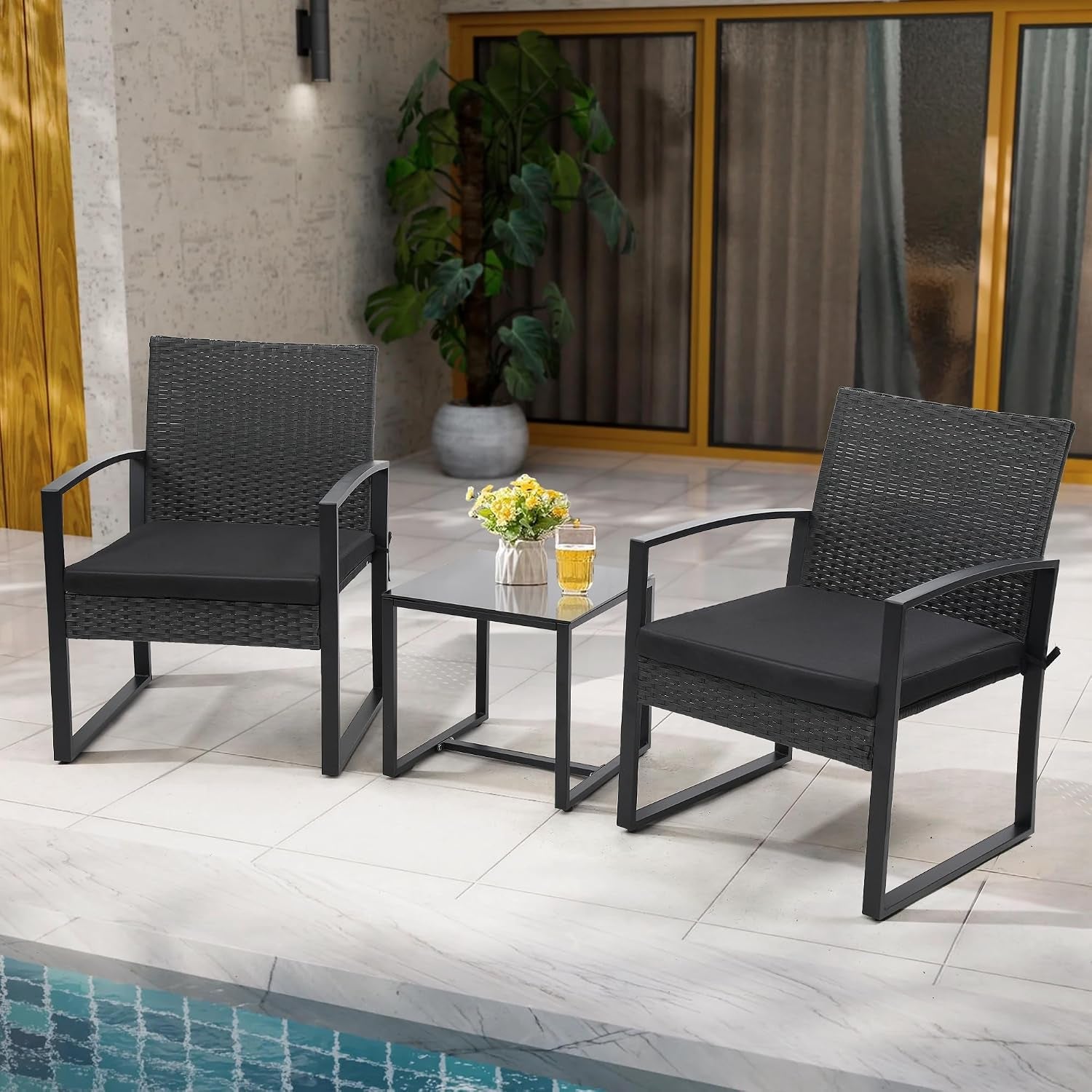 Two rattan chairs flanking a square tempered glass table beside a pool on tiled flooring