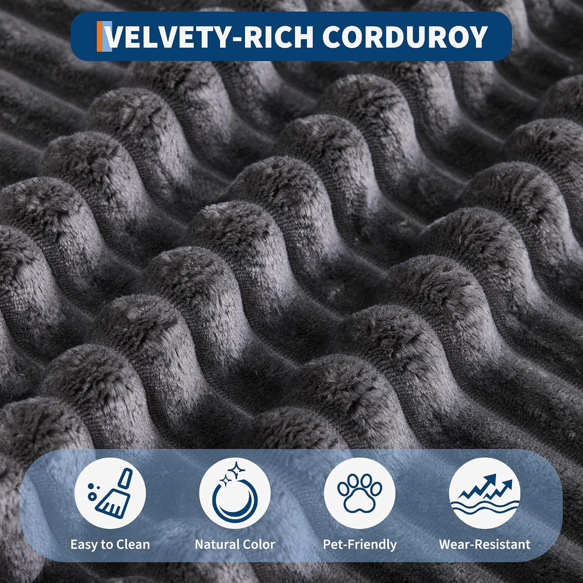 Close-up of plush, wide-ribbed corduroy fabric in dark gray showing raised velvety ribs.