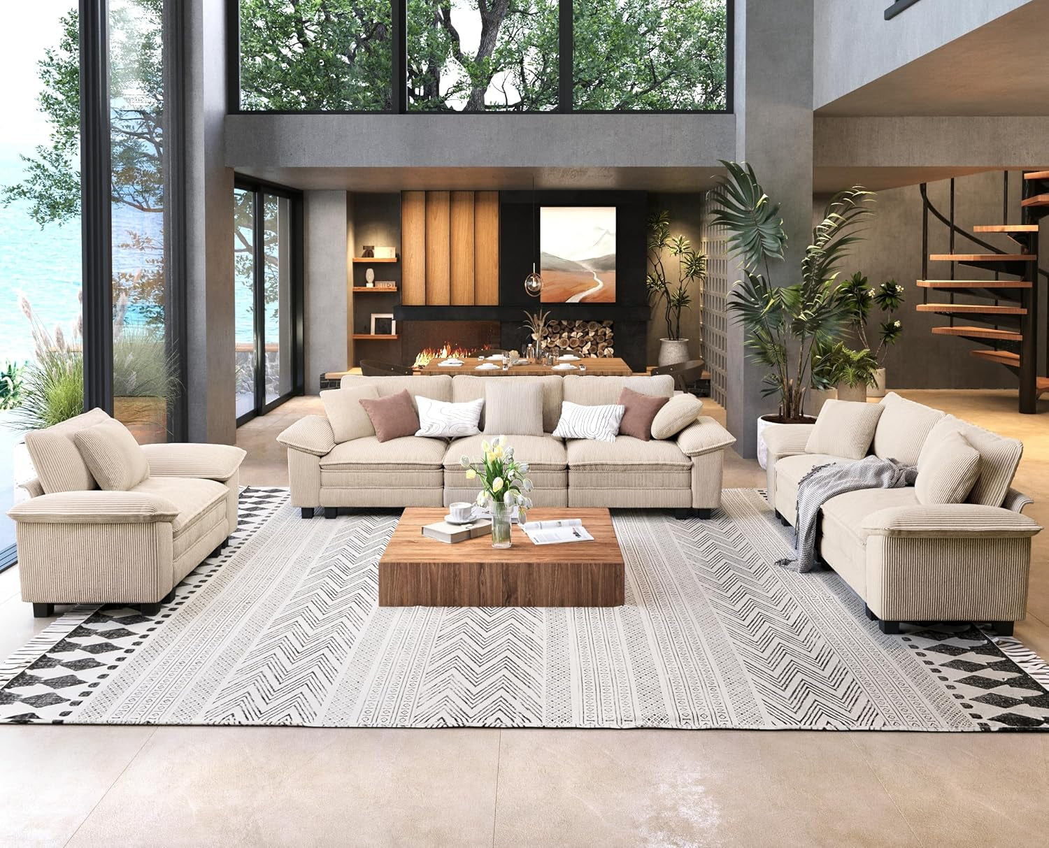 Cream-colored three-seat sofa and loveseat in a bright living room with large windows and a patterned rug