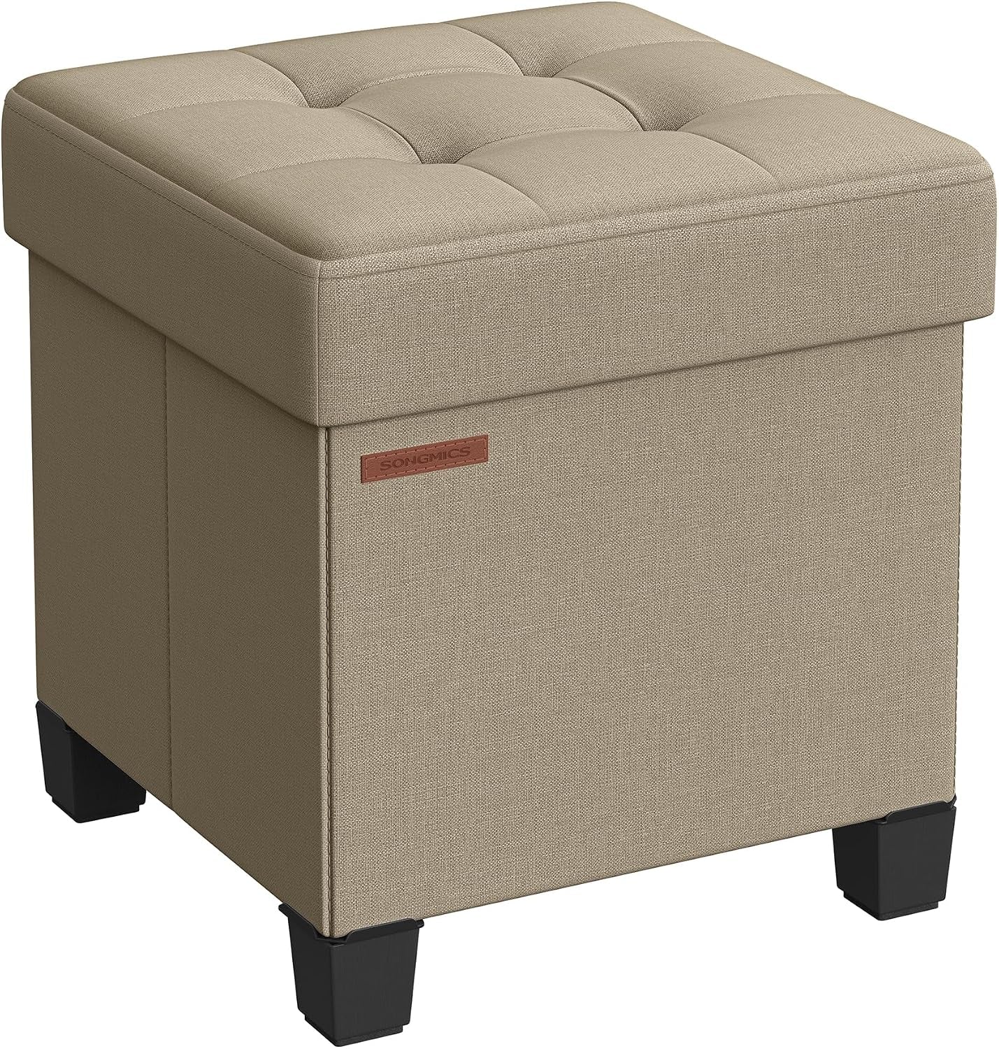 Three-quarter view of a tan linen-look storage ottoman featuring a tufted top and squared black feet