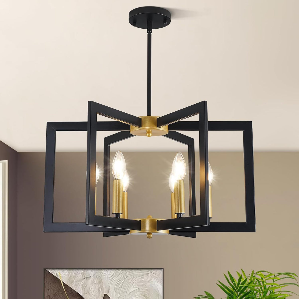 Close-up of black geometric chandelier showing gold candle sleeves and three lit bulbs beneath a ceiling mount.