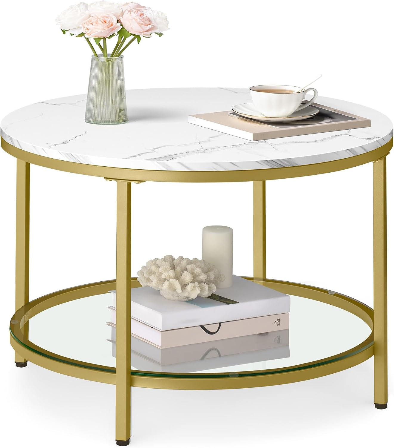Round coffee table with white marble-look top, gold metal frame and lower glass shelf, styled with a vase of roses, a teacup