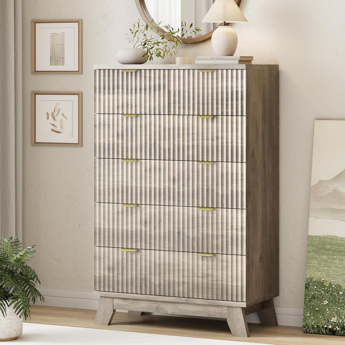 Tall wood-finish chest with fluted drawer fronts, gold handles and angled legs in a neutral bedroom corner.
