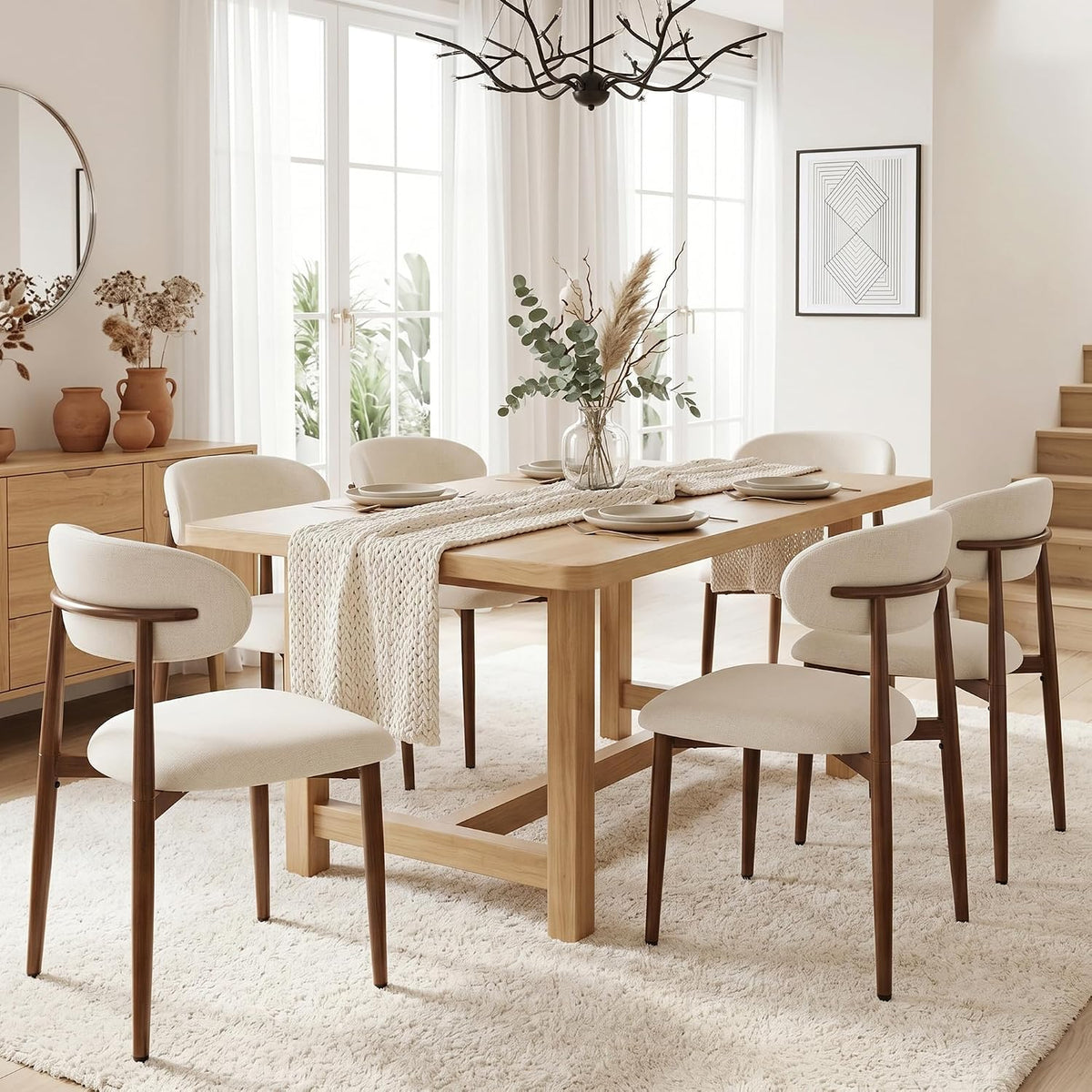 Light-legged beige chairs around a rectangular wood table in a bright dining room with rug