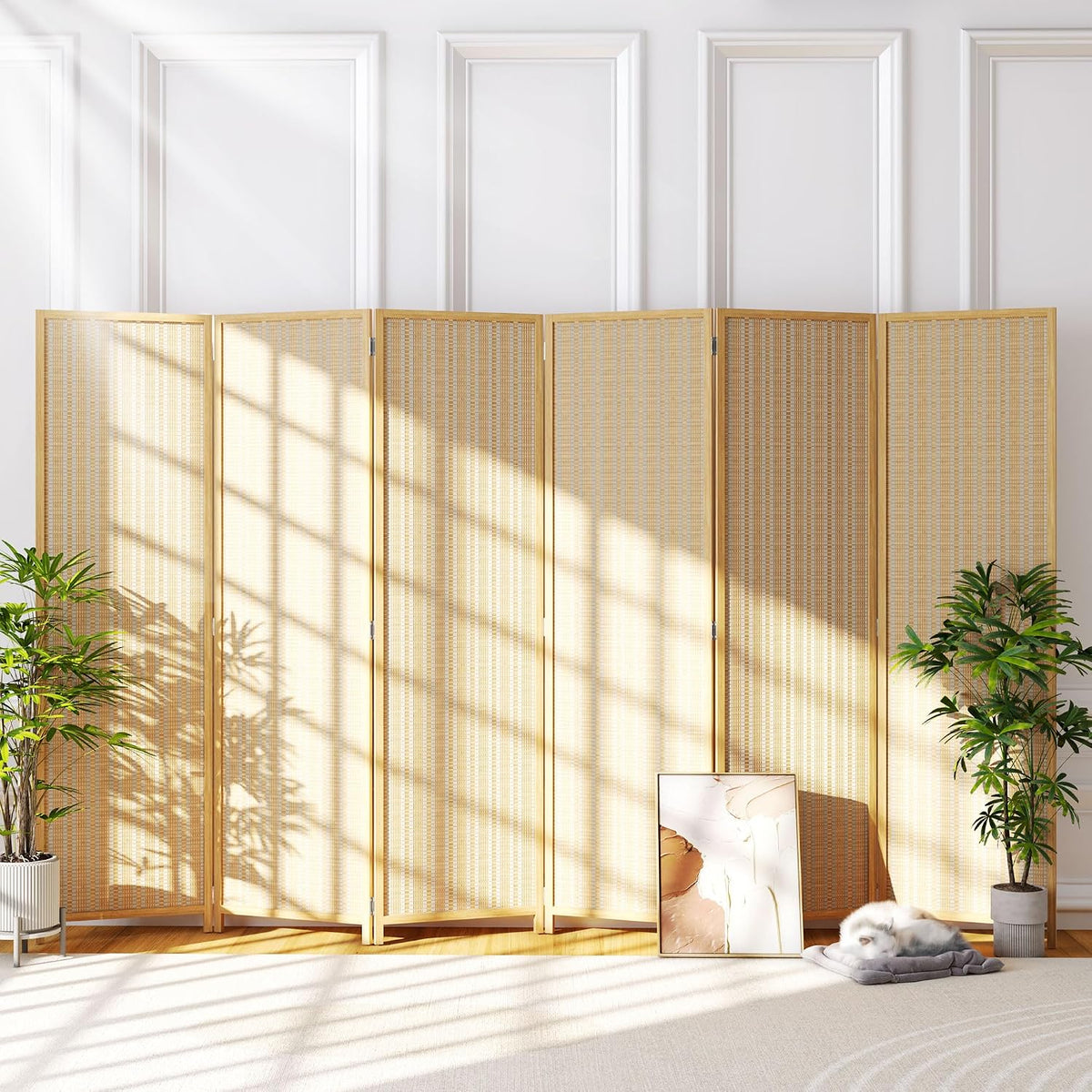 Low-angle room view of a light beige four-panel bamboo screen with sunlight and plants