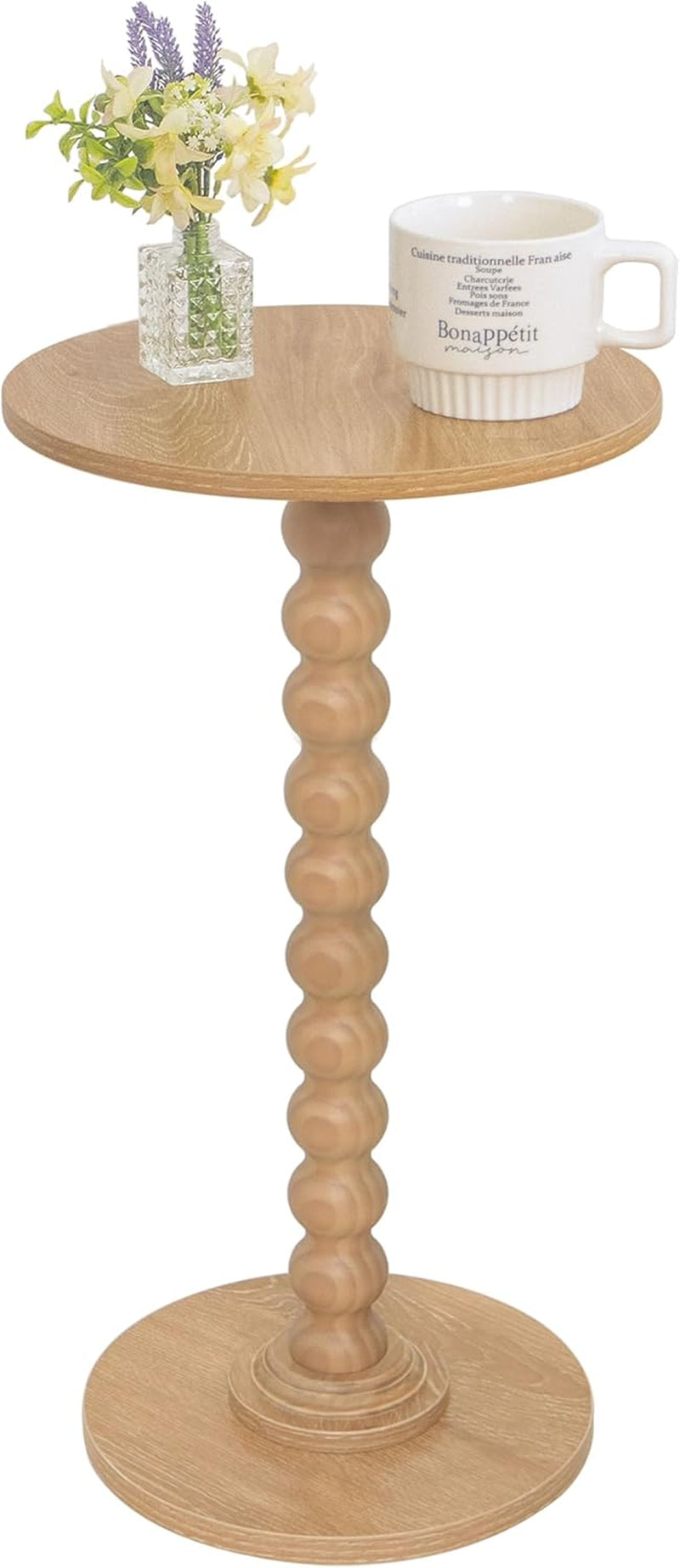 Light oak round side table with beaded spindle column, small vase and mug on surface