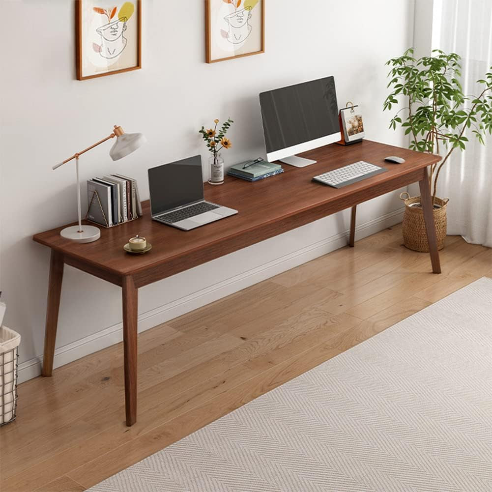 Walnut long desk styled as a double workstation with a laptop and desktop monitor, side view
