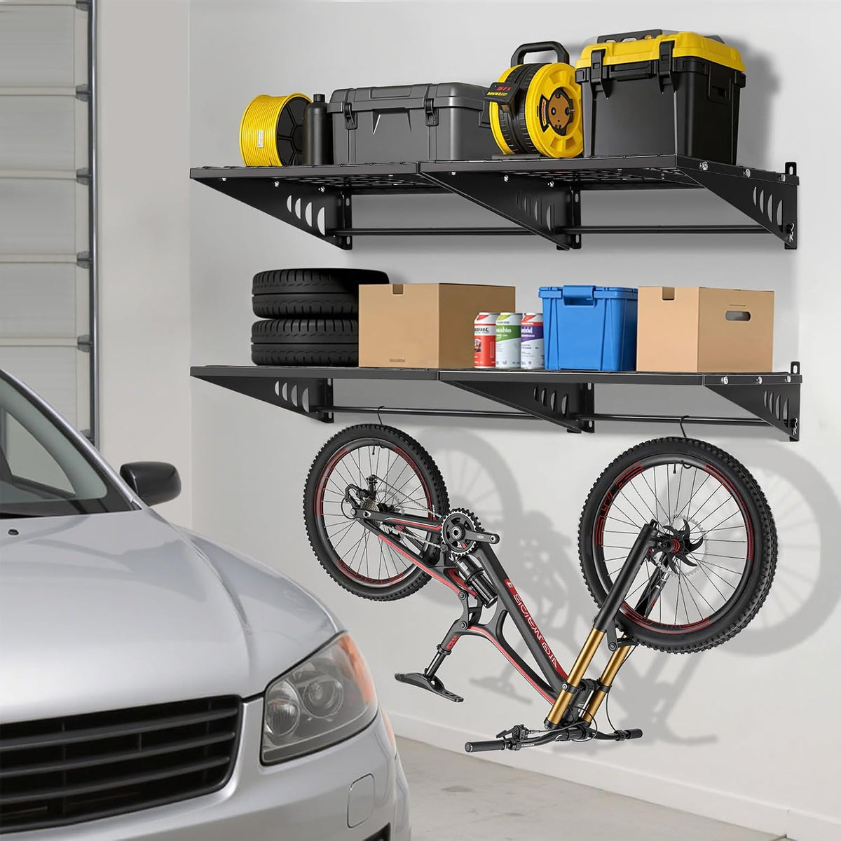 Two black wall-mounted wire shelves holding boxes and tools over a folded bicycle, with a car parked nearby in a garage.