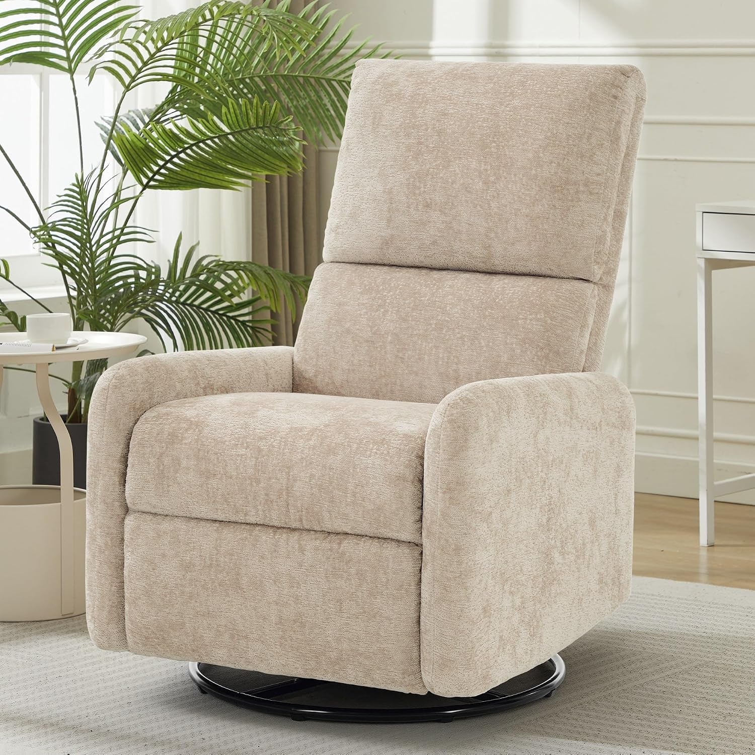 Light beige fabric swivel rocking chair in a bright room, shown three-quarters front with black base.