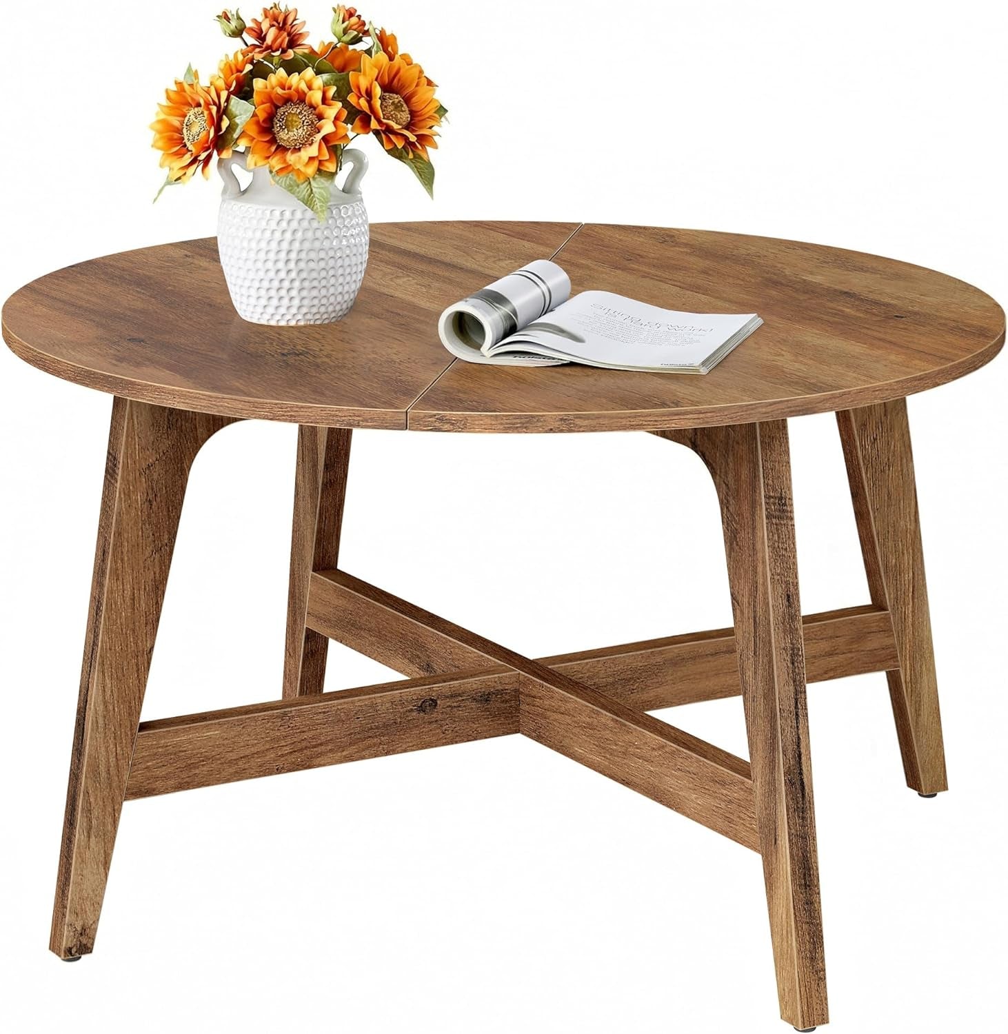 Honey brown round coffee table front view on a white background with a vase of flowers and an open magazine