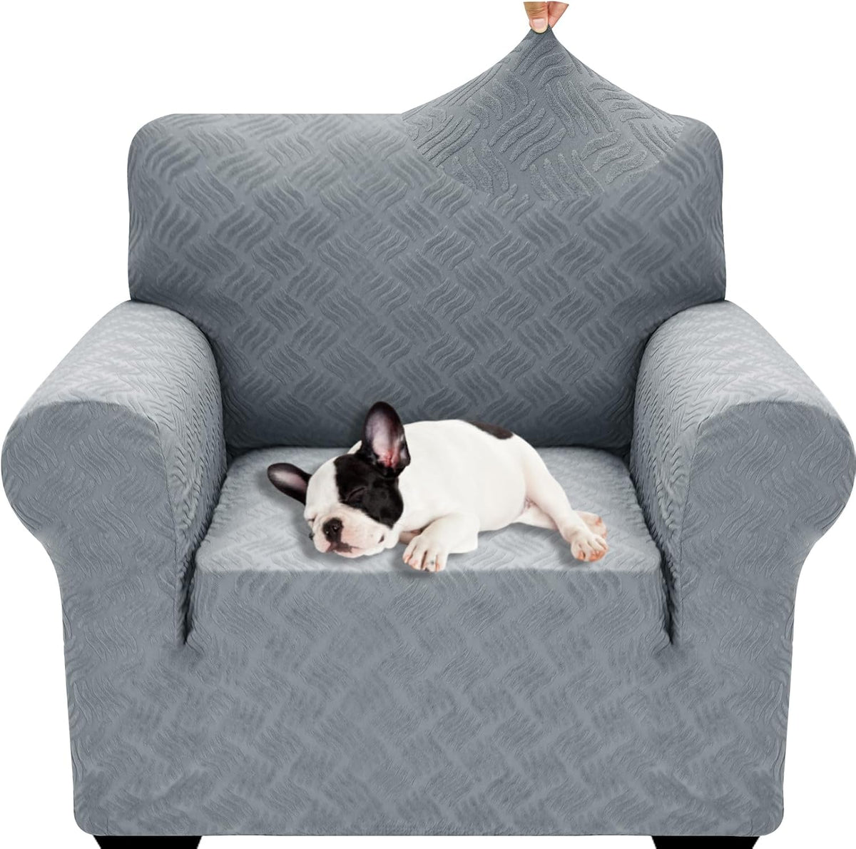 Light gray textured stretch cover on an armchair with a small sleeping black-and-white dog on the seat.