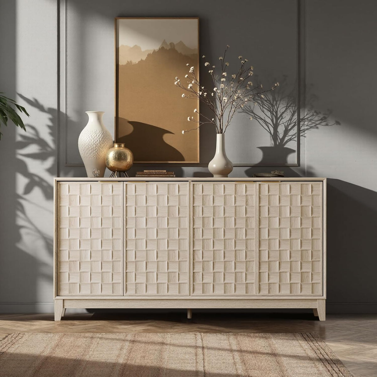 Light-finish sideboard with checkerboard doors styled against a gray wall with vases, art and soft shadows.