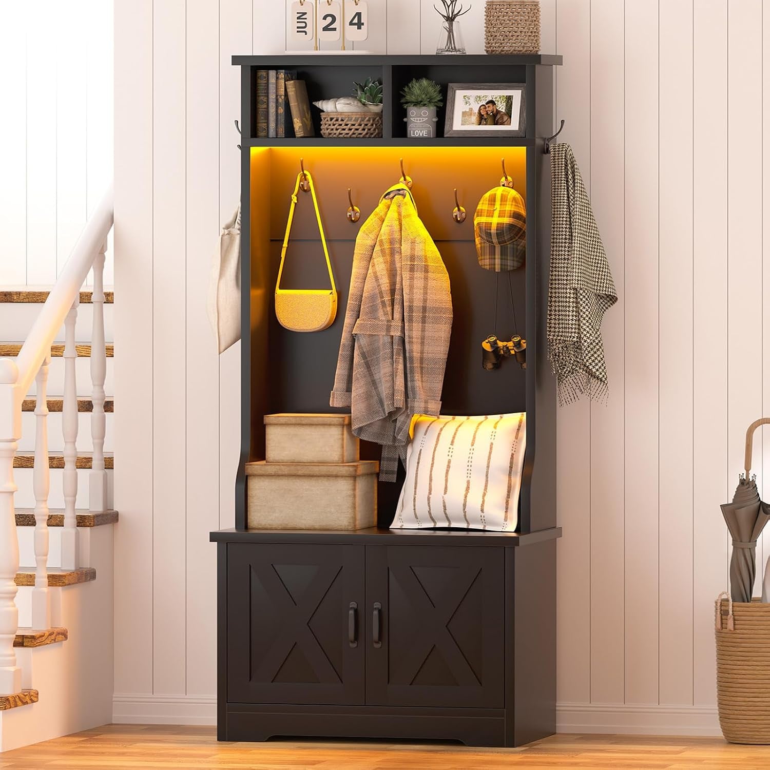 Side-angle of a single bay in dark finish showing a curved side panel, bench cushion and stacked storage boxes.