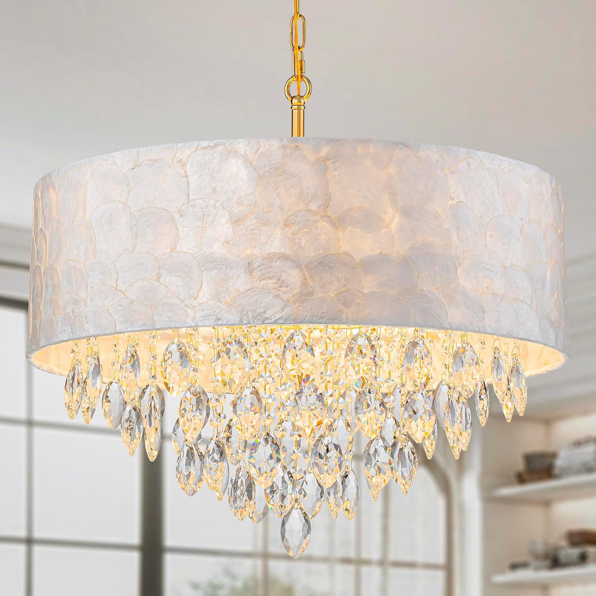 Front view of the illuminated drum pendant showing many clear crystal drops beneath a textured white shade.