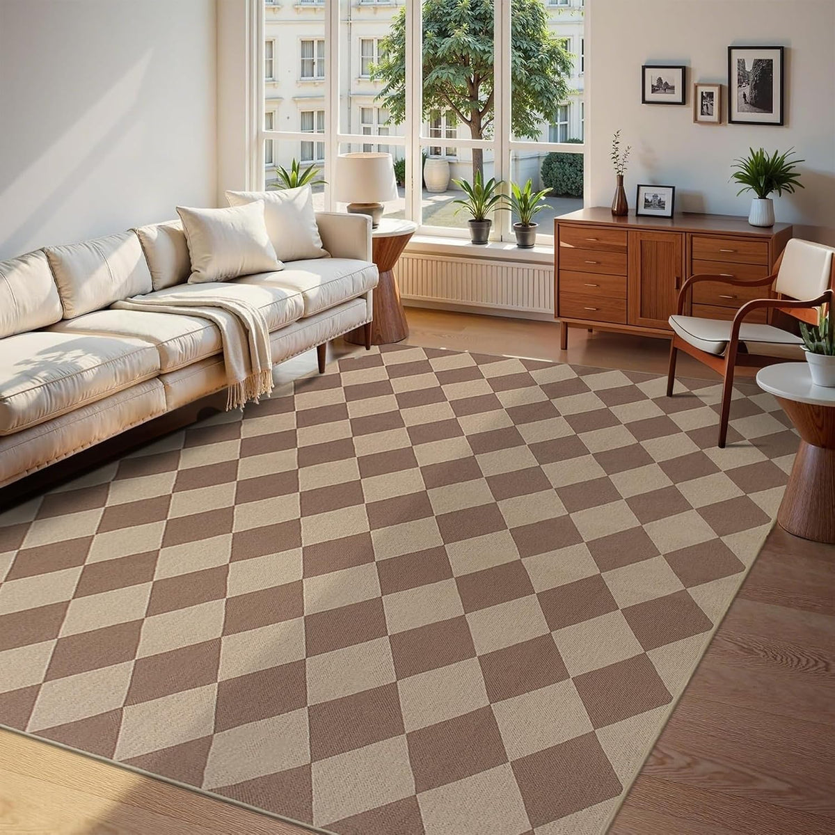 Large two-tone checker rug anchoring a light sofa and midcentury console under a tall window.