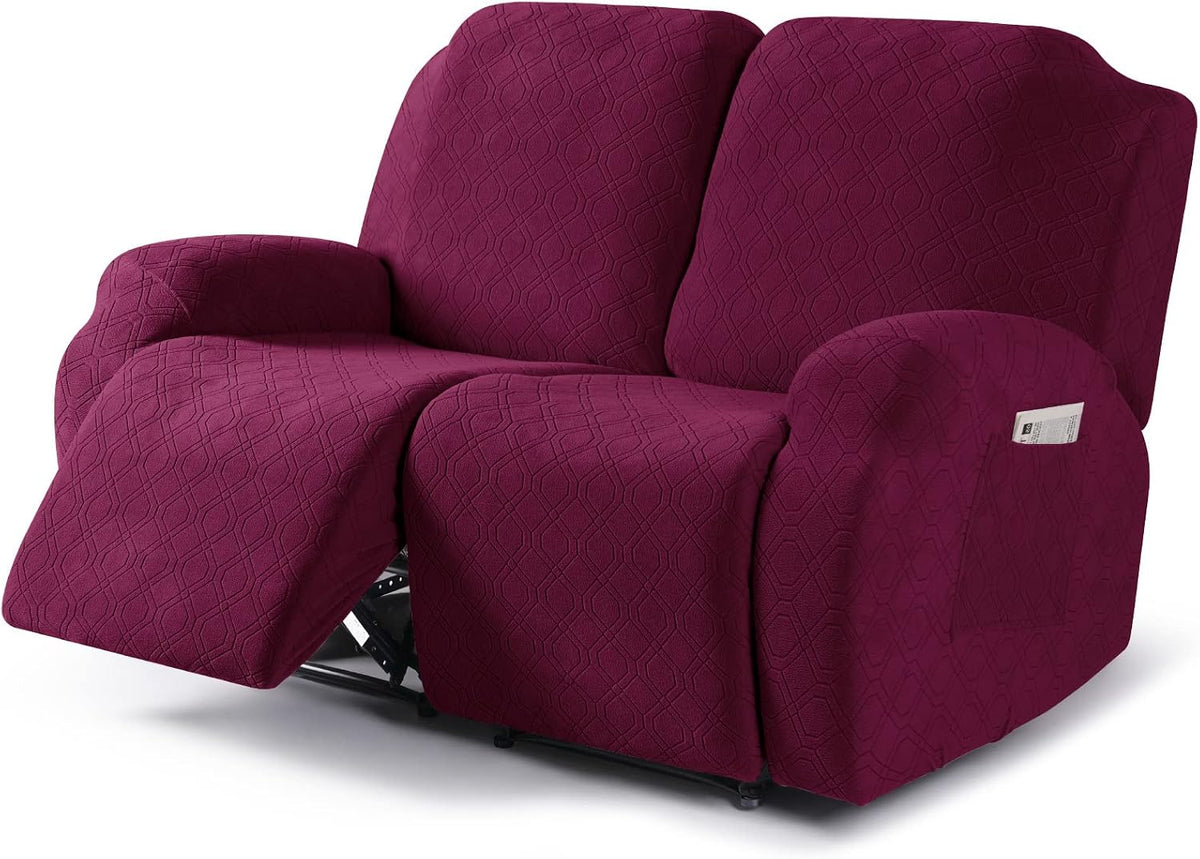 Recliner sofa covered in textured plum slipcover with left footrest extended and stitched geometric pattern.