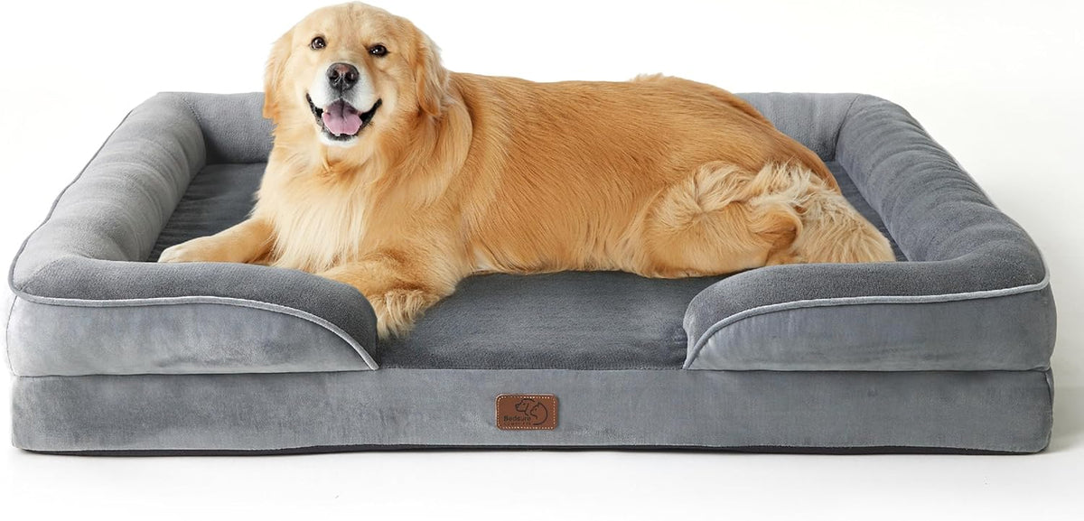 Golden retriever resting on rectangular all-gray bolstered dog bed with plush sleeping surface.