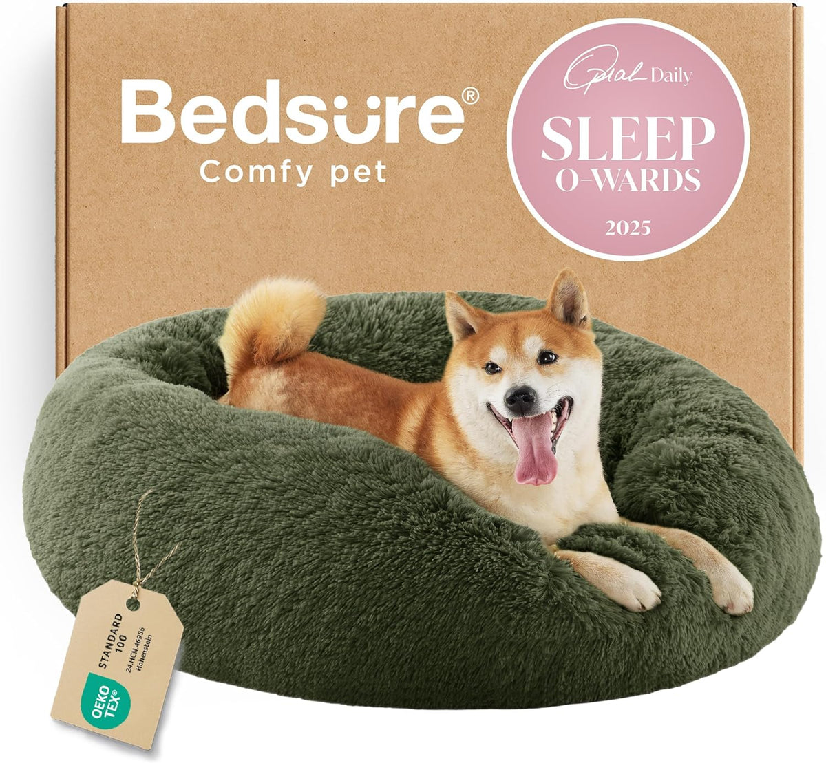 Dark green round faux-fur donut bed shown fronted by a happy dog and branded cardboard box behind.