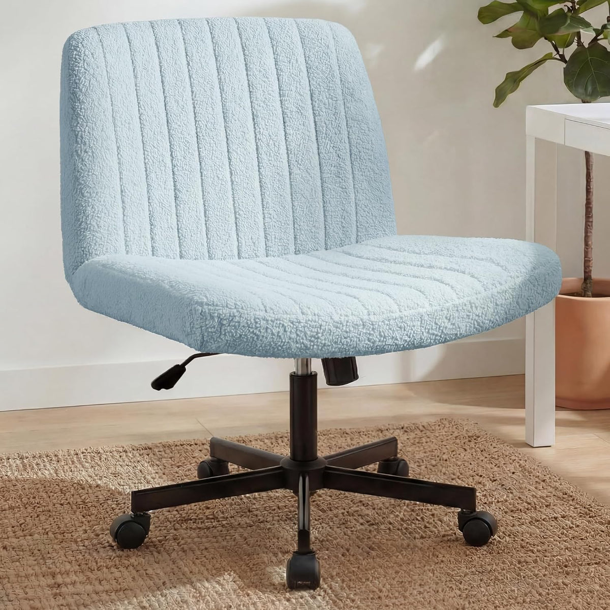 Pale blue textured swivel chair with ribbed seat and back on a woven rug near a potted plant and table.
