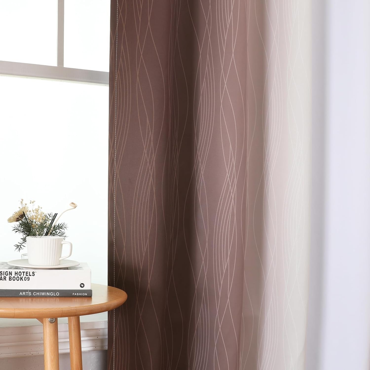 Close-up of ombre panel showing wavy-line pattern beside a small table with books and a cup on top