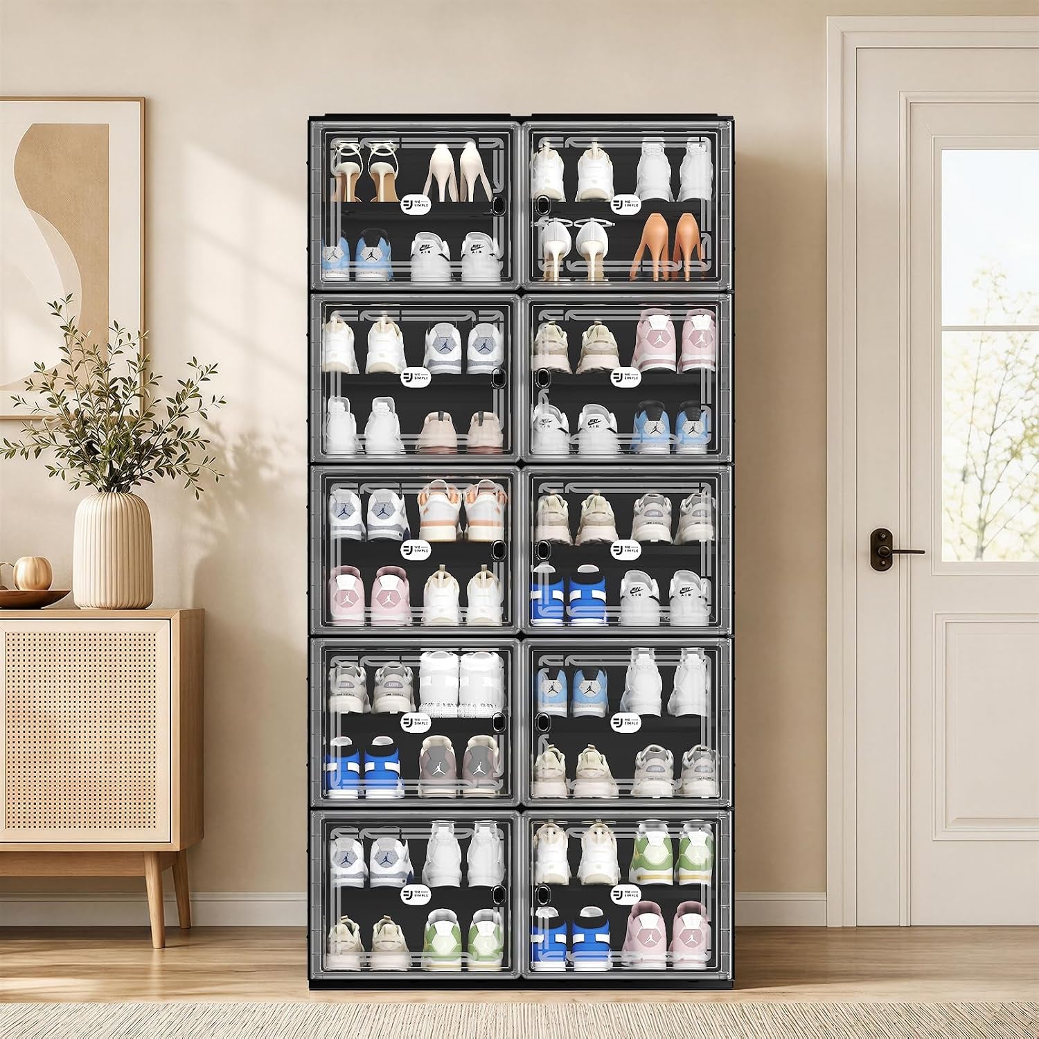 Black modular shoe cabinet front view in an entryway, two-column stacked compartments with clear doors