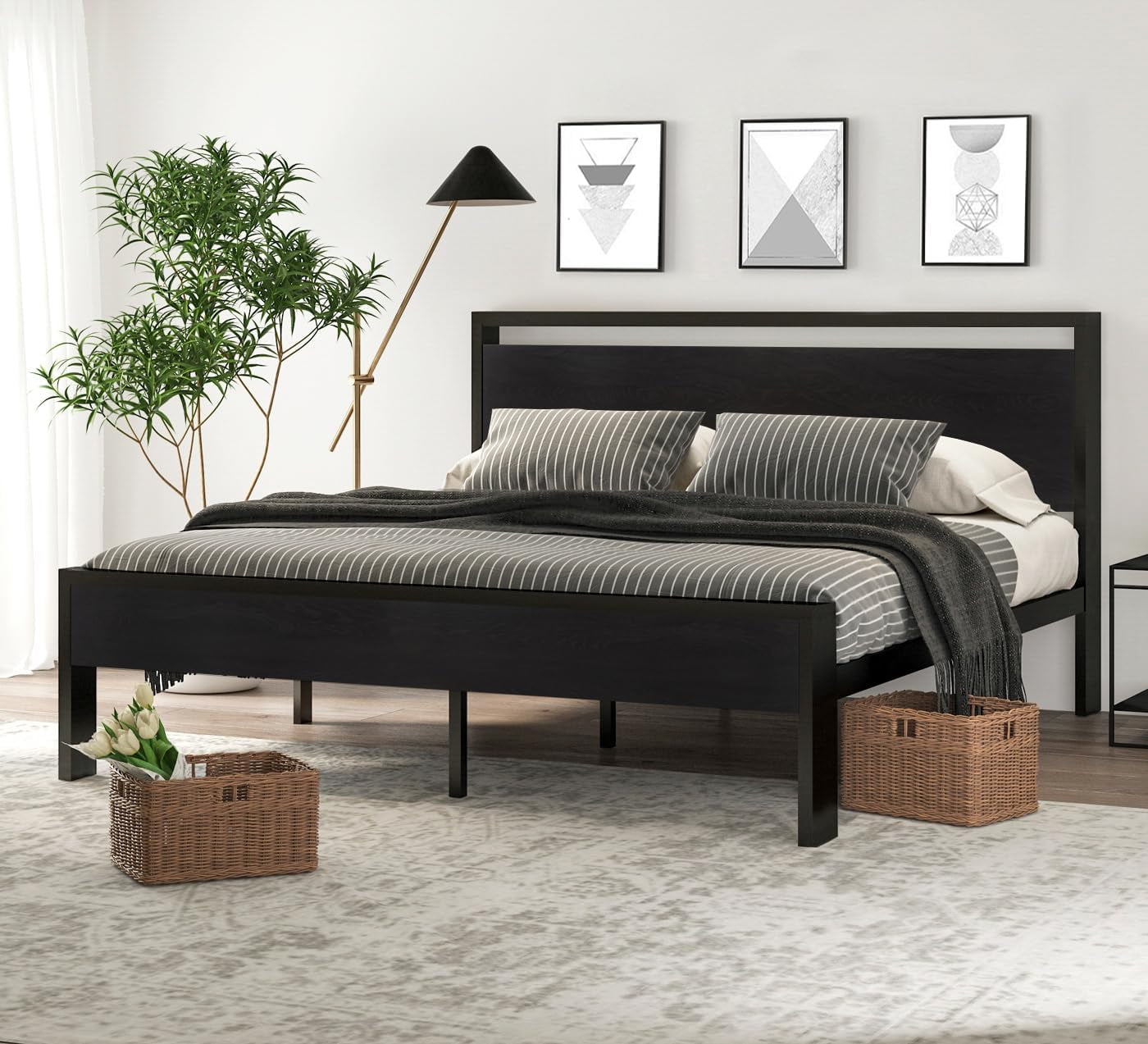 Black metal frame platform bed with matching black wooden headboard and footboard in a bright bedroom