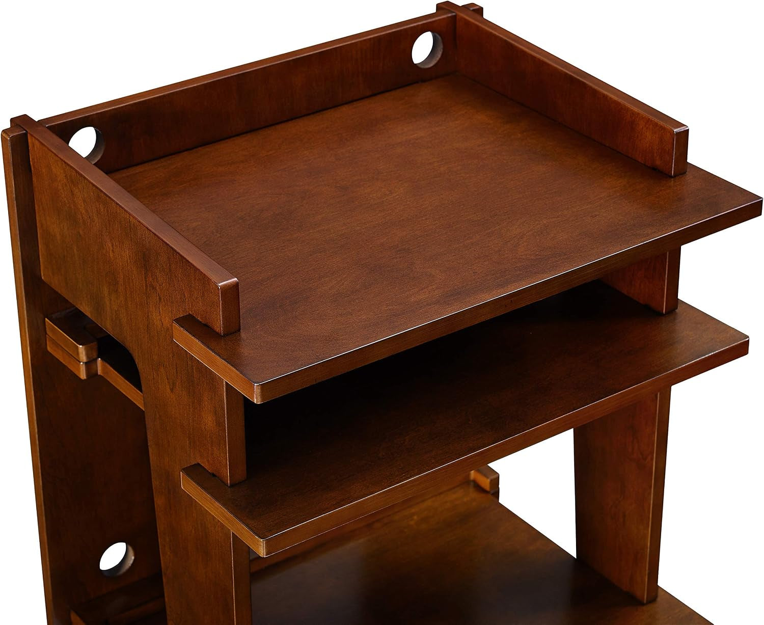 Close-up of the console's top two shelves showing mahogany finish and rounded cable holes at the back.