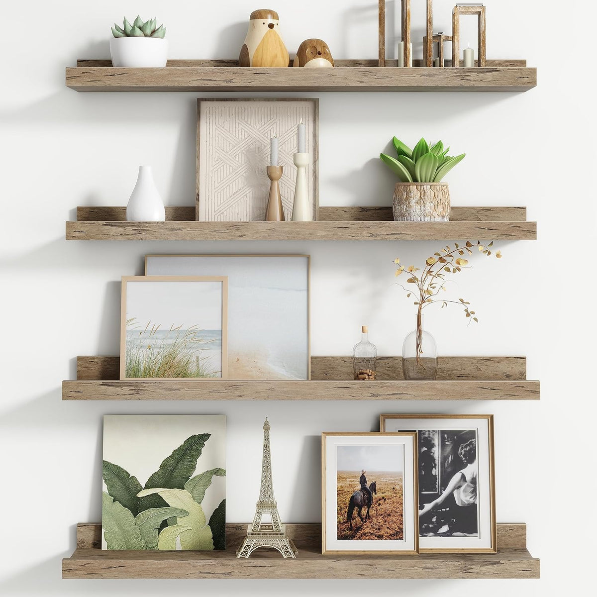 Three reclaimed-look wood floating ledges styled with frames, plants and small objects