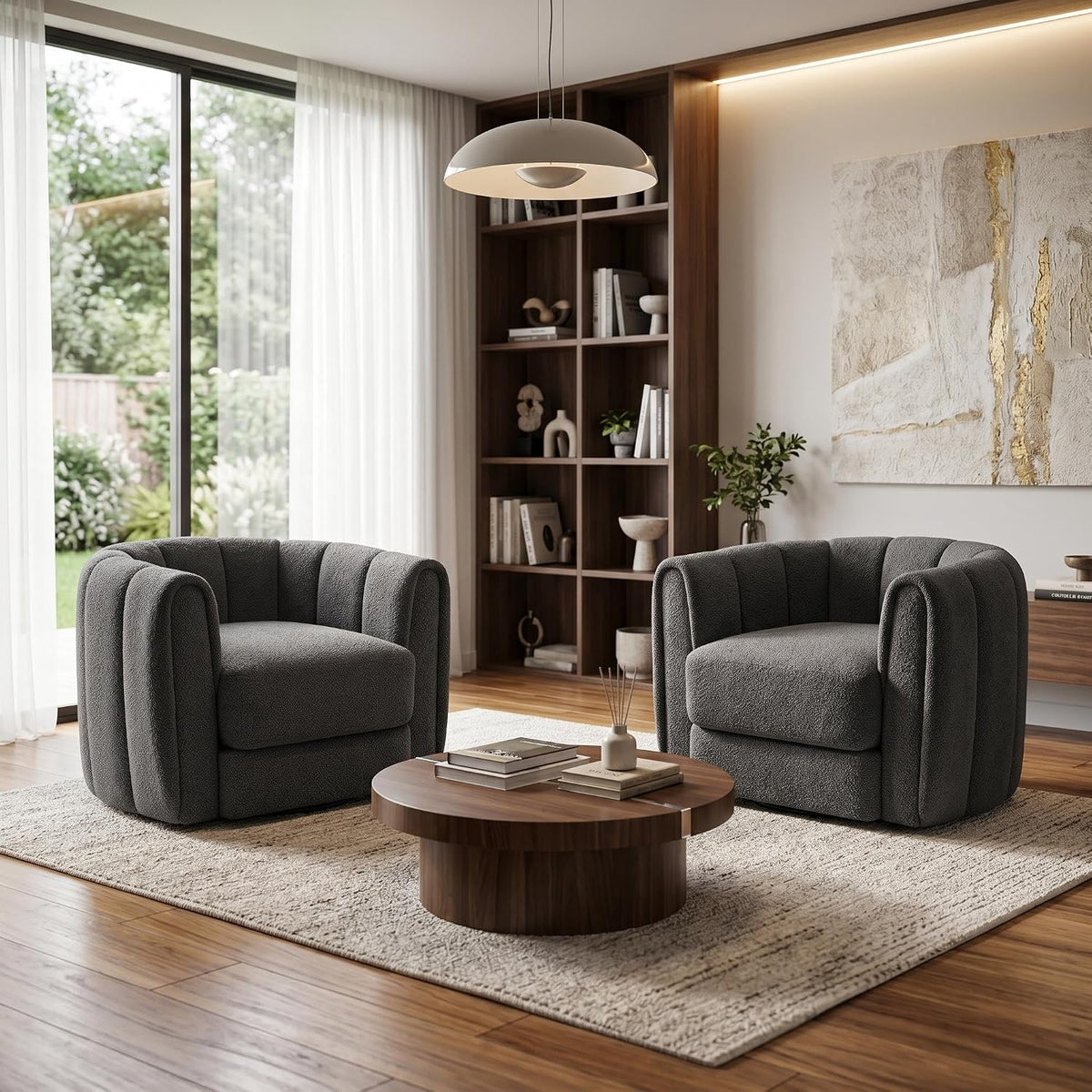 Pair of dark gray rounded barrel swivel chairs in a sunlit living room beside a low wood coffee table.