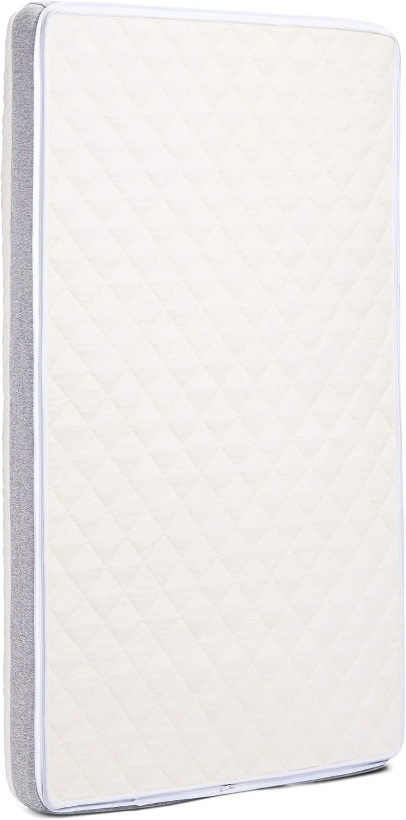 Tall vertical front view of a quilted crib mattress standing on its edge against a white background