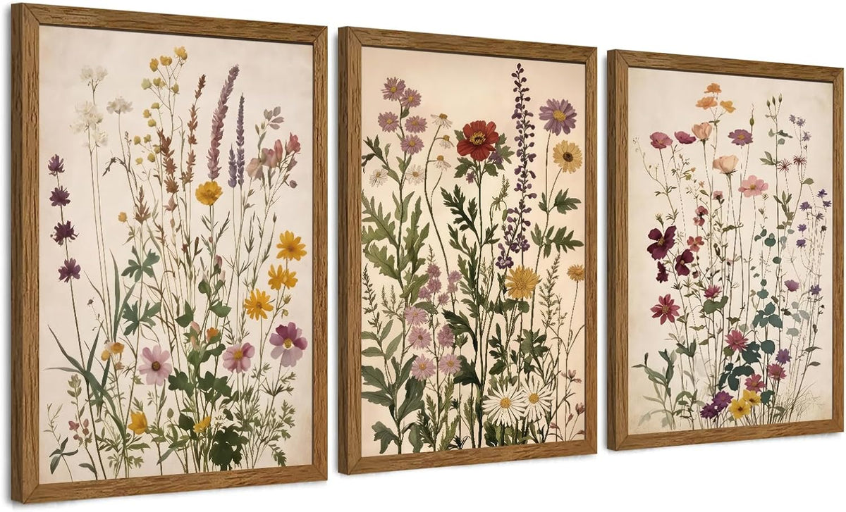 Three framed vertical botanical prints with tall wildflower illustrations, shown at a slight left-facing angle.
