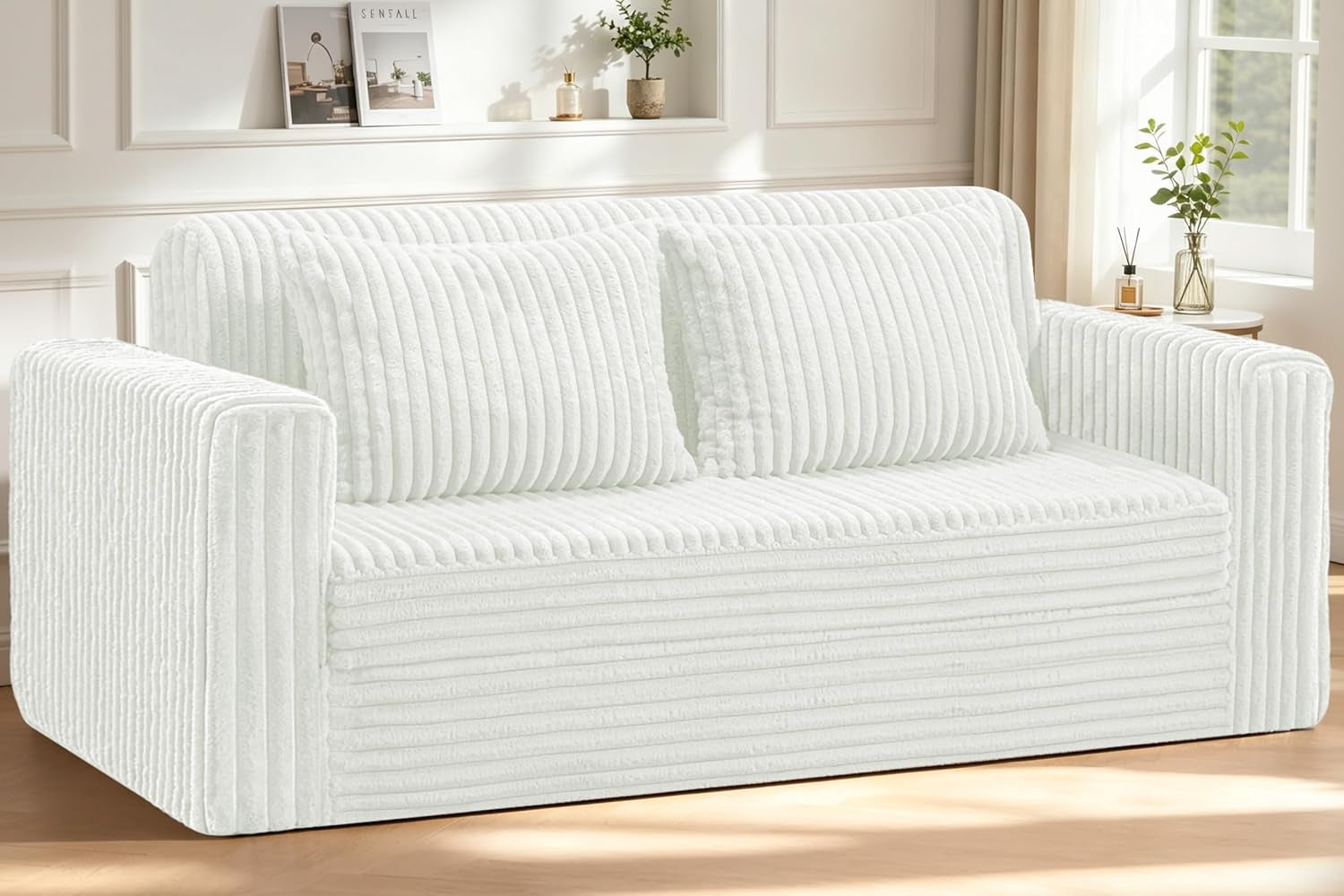 White plush fabric loveseat sofa facing front with two matching pillows in a bright living room
