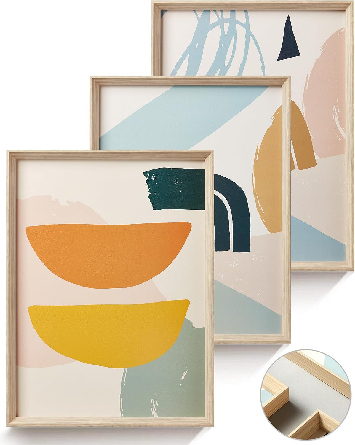 Three framed modern abstract prints with bold organic shapes in orange, mustard, teal and sage, plus a wood-frame corner