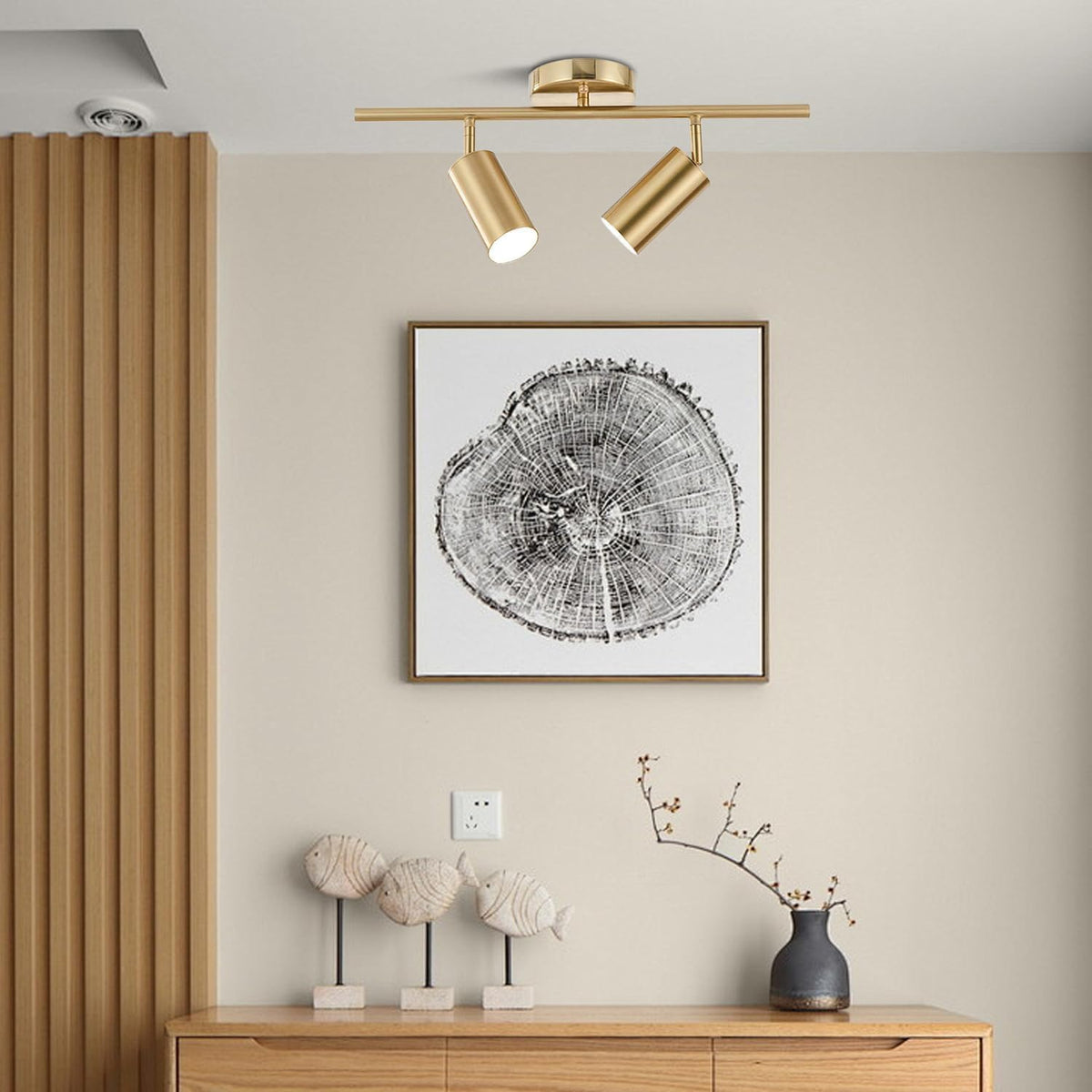 Gold 2-light ceiling track fixture mounted in a neutral entryway above artwork and console table