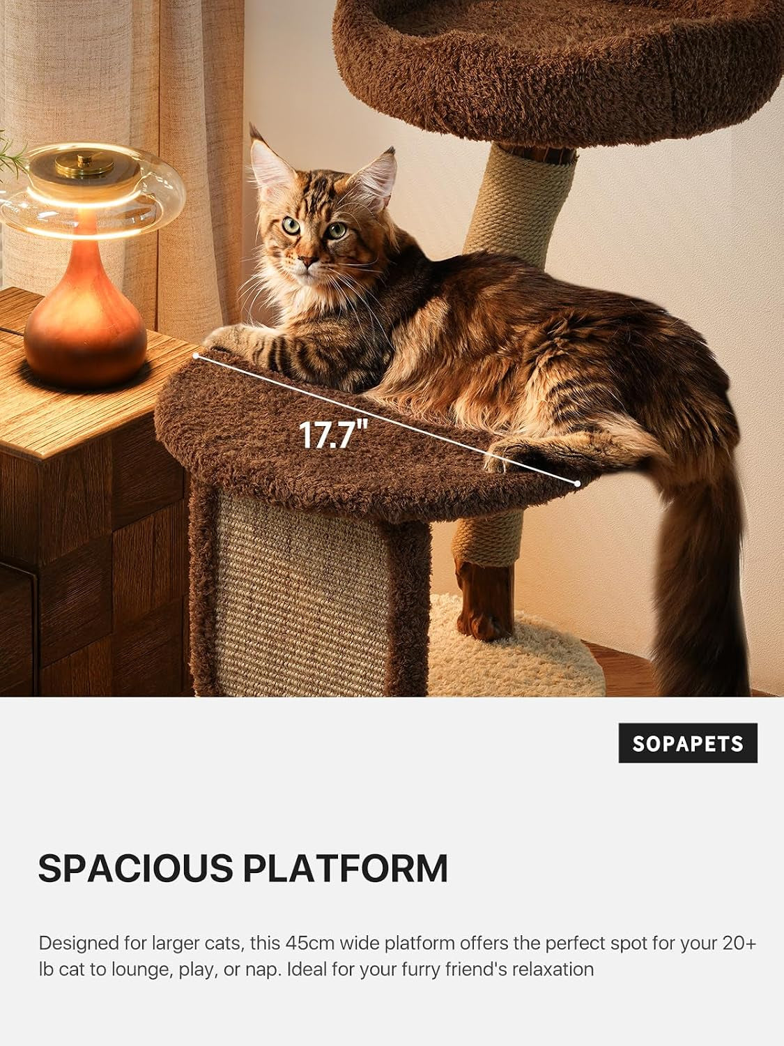 Side view of a cat lounging on a brown plush platform on the cat tree, showing the wide flat lounging surface