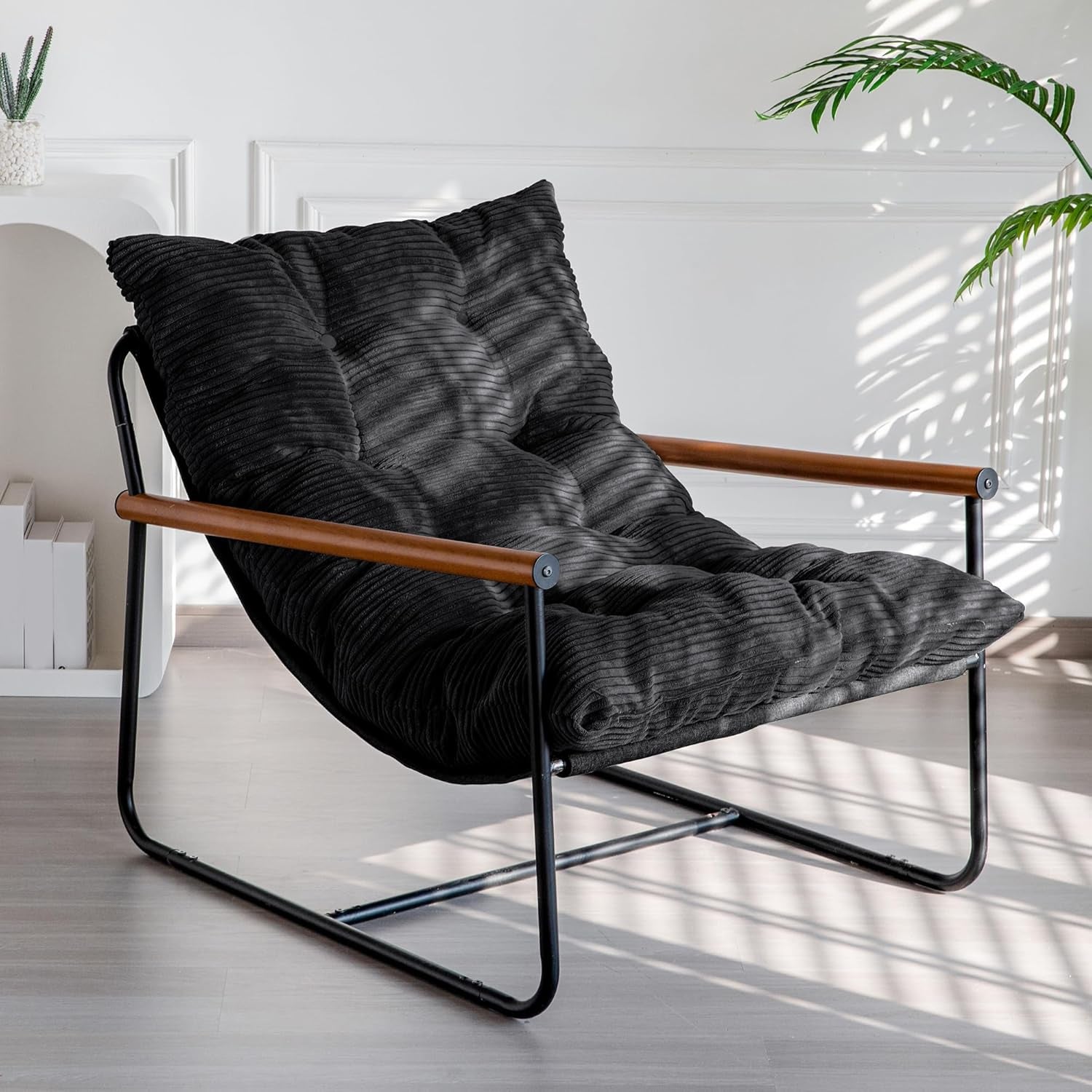 Three-quarter view of a black corded cushion chair with black metal frame and wooden armrests