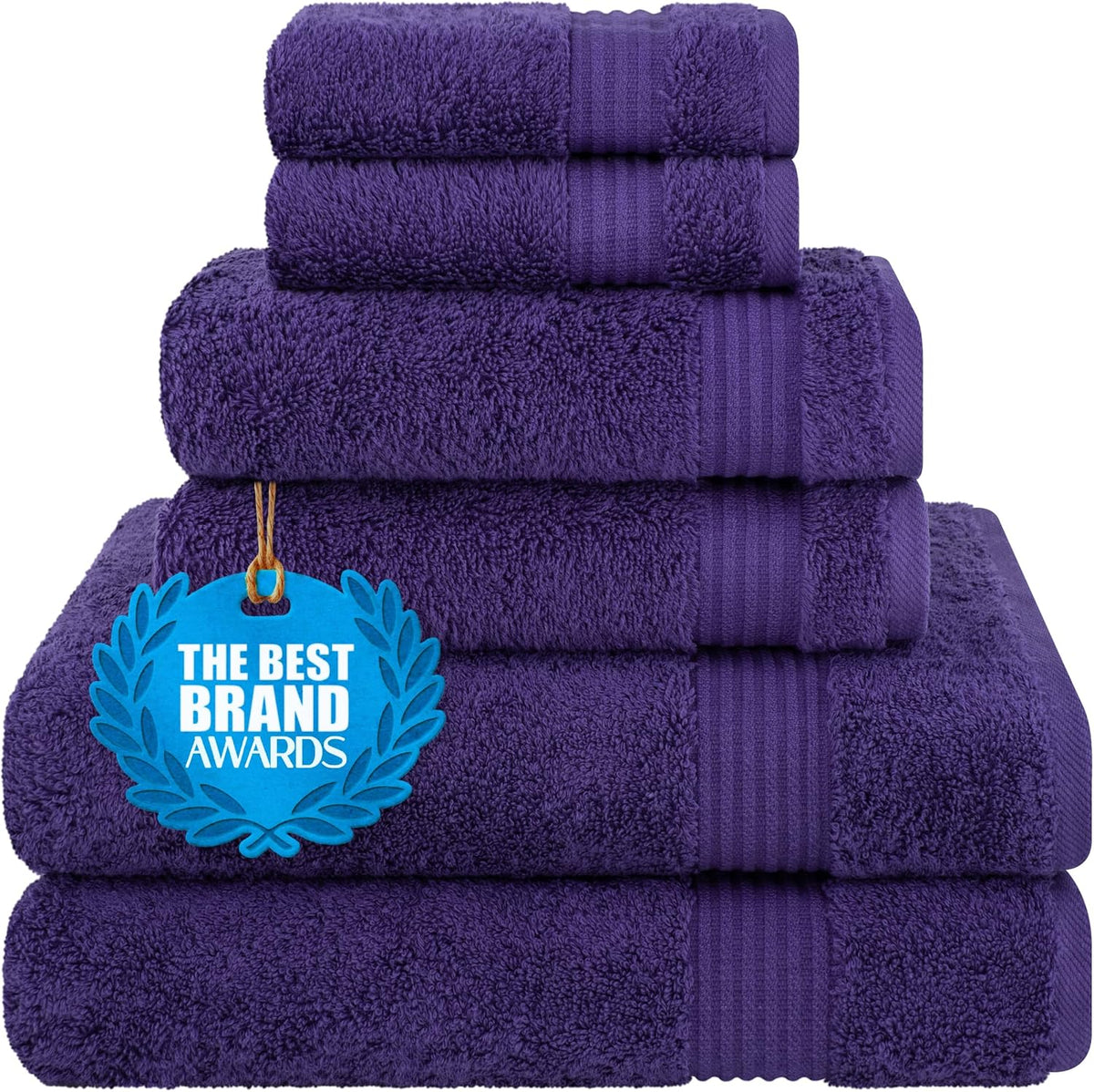 Stack of deep purple folded towels with a blue award tag hanging at the front