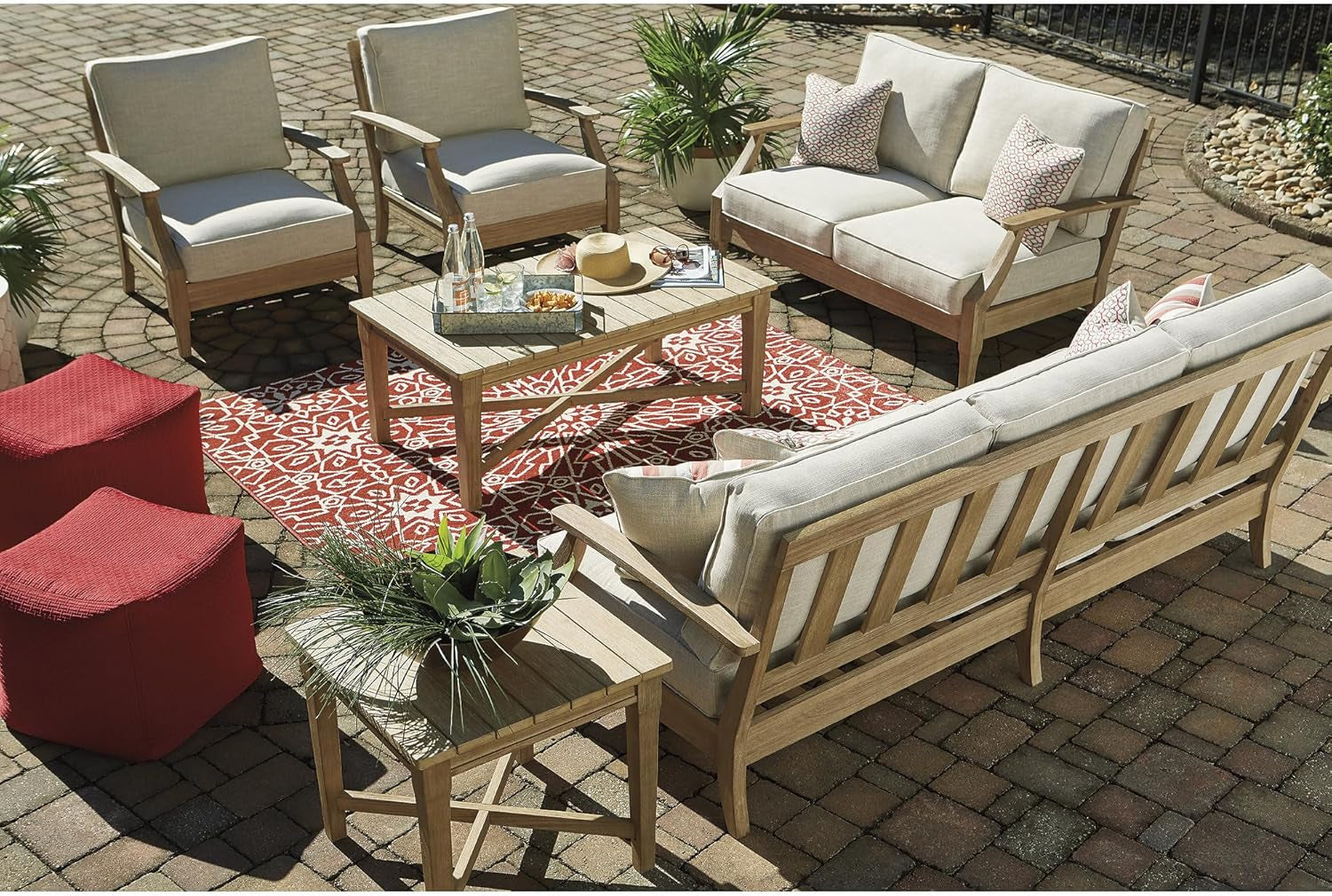 Overhead patio arrangement showing the three-seat sofa with coordinating seating, table and red patterned rug