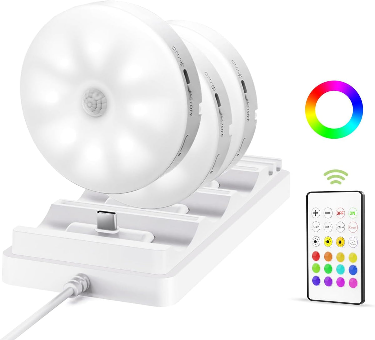 Three white puck lights seated on a white charging dock with a USB-C charging post and a remote shown at right.