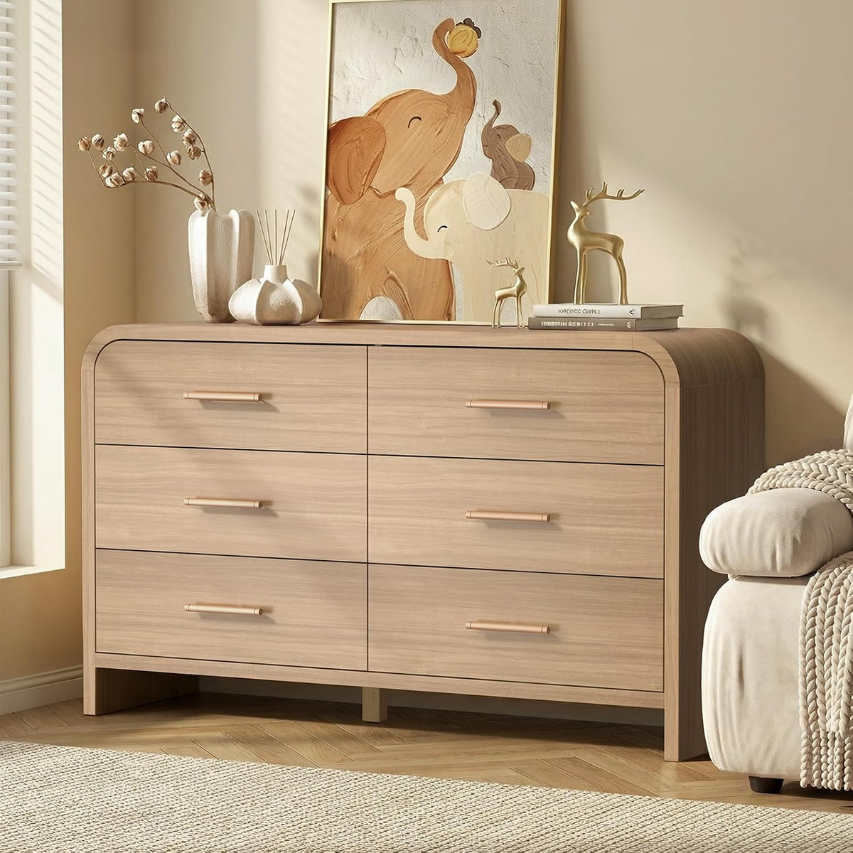 Close front view of a curved six-drawer dresser with rounded corners and metal bar handles.
