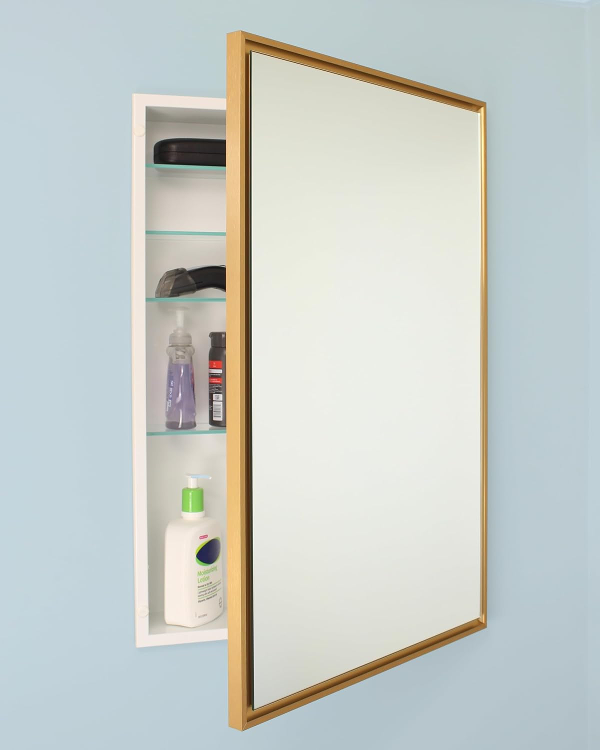Portrait gold-framed recessed medicine cabinet with mirrored door open, left interior showing three glass shelves and