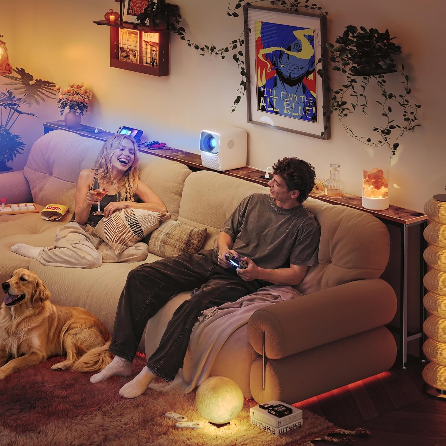 Couple relaxing on a couch with a long console table behind holding a projector and decorative items, dog on the floor.
